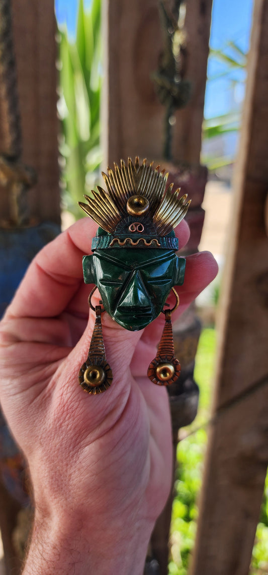 Large sized Vintage 1950's handmade Mayan Aztec Chieftain statement brooch or pendant.
The Chieftain brooch/pendant is made up of a well carved polished Green Onyx face mask, topped with a ornamental Brass feather headdress with Copper band, and two long