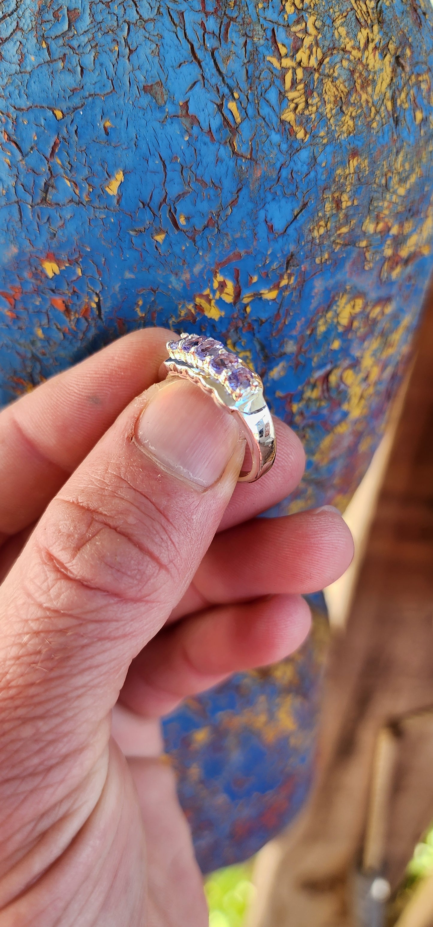 This exquisite Half Eternity style band featuring Natural Tanzanite Gemstones.