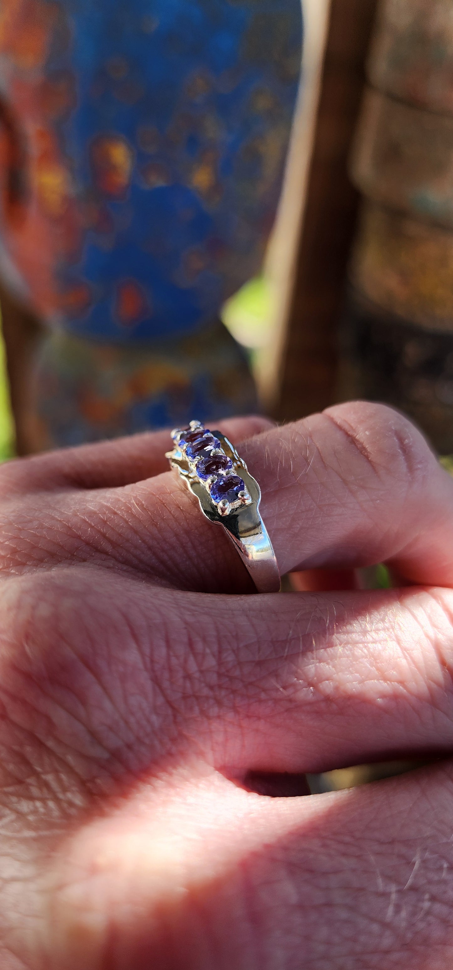 This exquisite Half Eternity style band featuring Natural Tanzanite Gemstones.