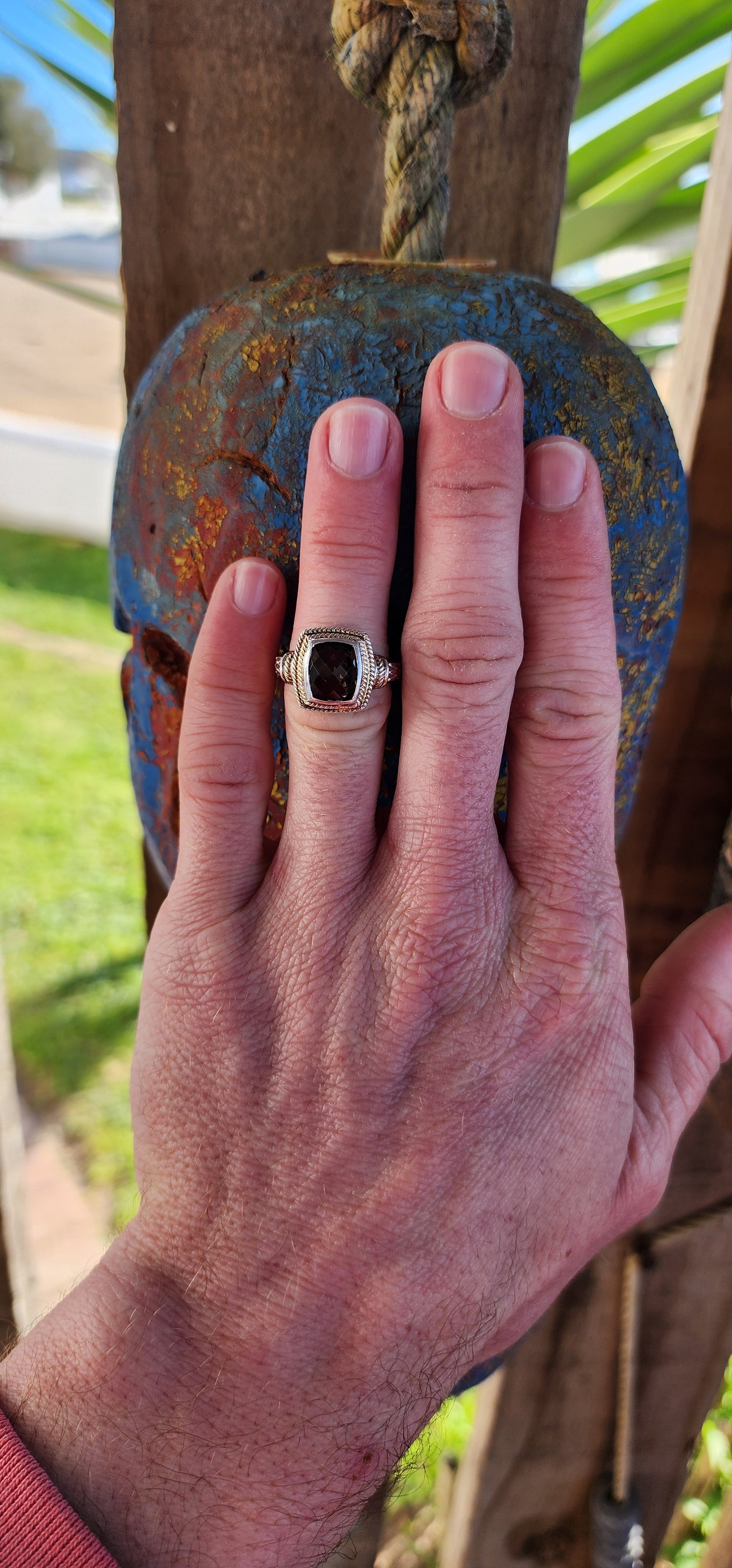 A beautifully made Designer Sterling Silver ring showcasing a Checkerboard faceted Rectangular Cushion cut Smoky Quartz Gemstone, bezel/tube set and positioned in the center.
The Smoky Quartz is encircled by a double cable halo.