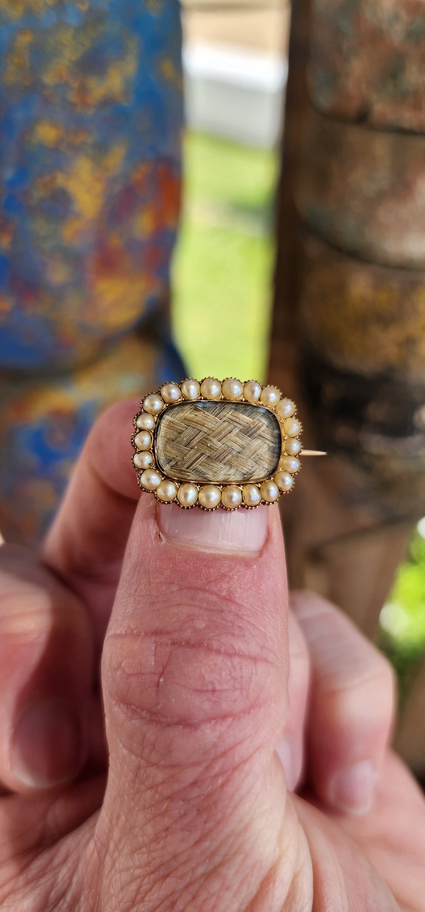 Antique late Georgian early Victorian era 9ct Gold and Seed Pearls Mourning brooch in a Rounded Rectangular form.The central panel featuring blonde plaited/braided hair under a bevelled Stuart Crystal cover.Framed in a halo of prong-set Seed Pearls.