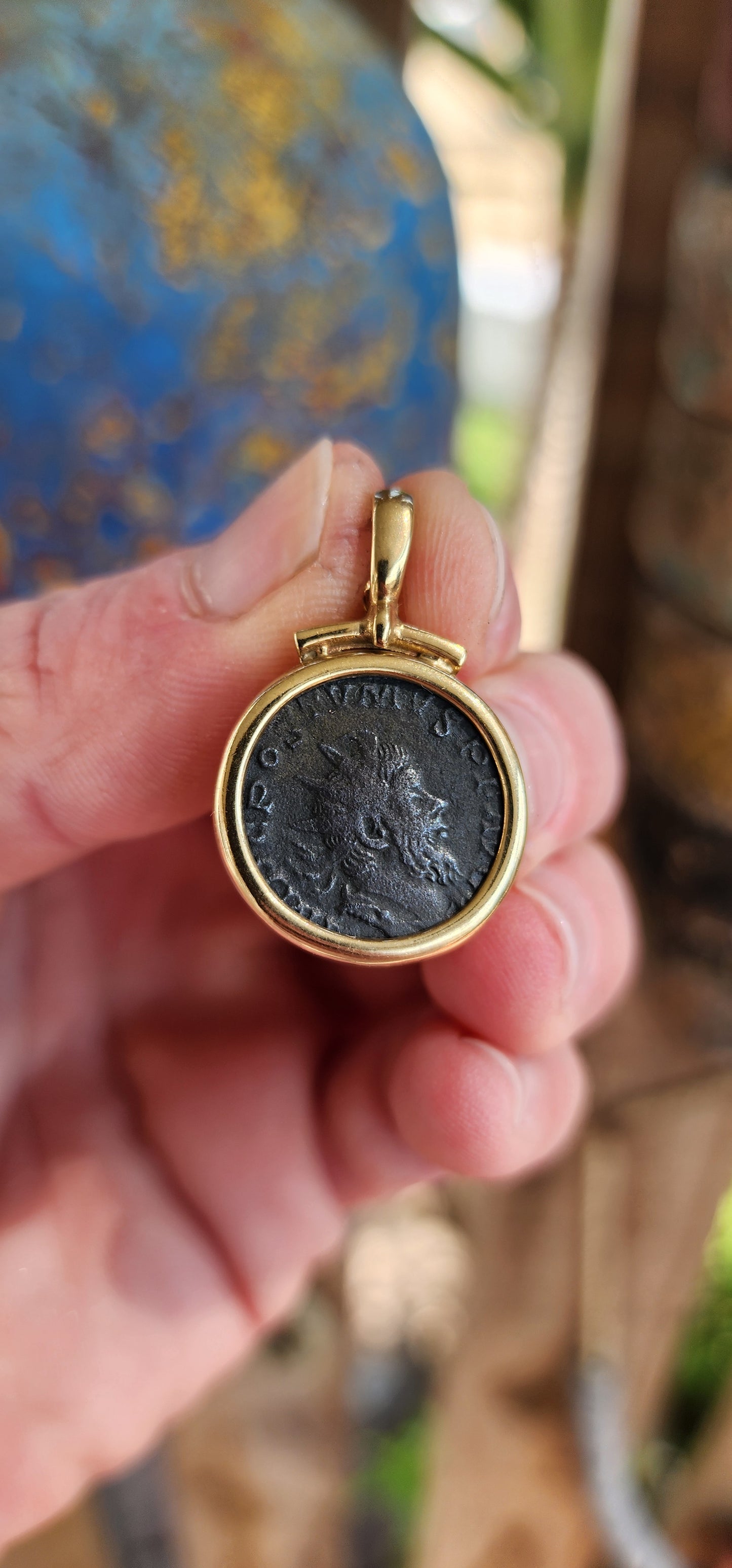 A fabulous Ancient Roman Bronze coin pendant featuring Postumus Antoninianus in a 8ct Yellow Gold bezel with open/close bail.
This pendant features a true Ancient Roman Bronze coin that was lightly circulated and depicts Postumus Antoninianus 260-269 AD.