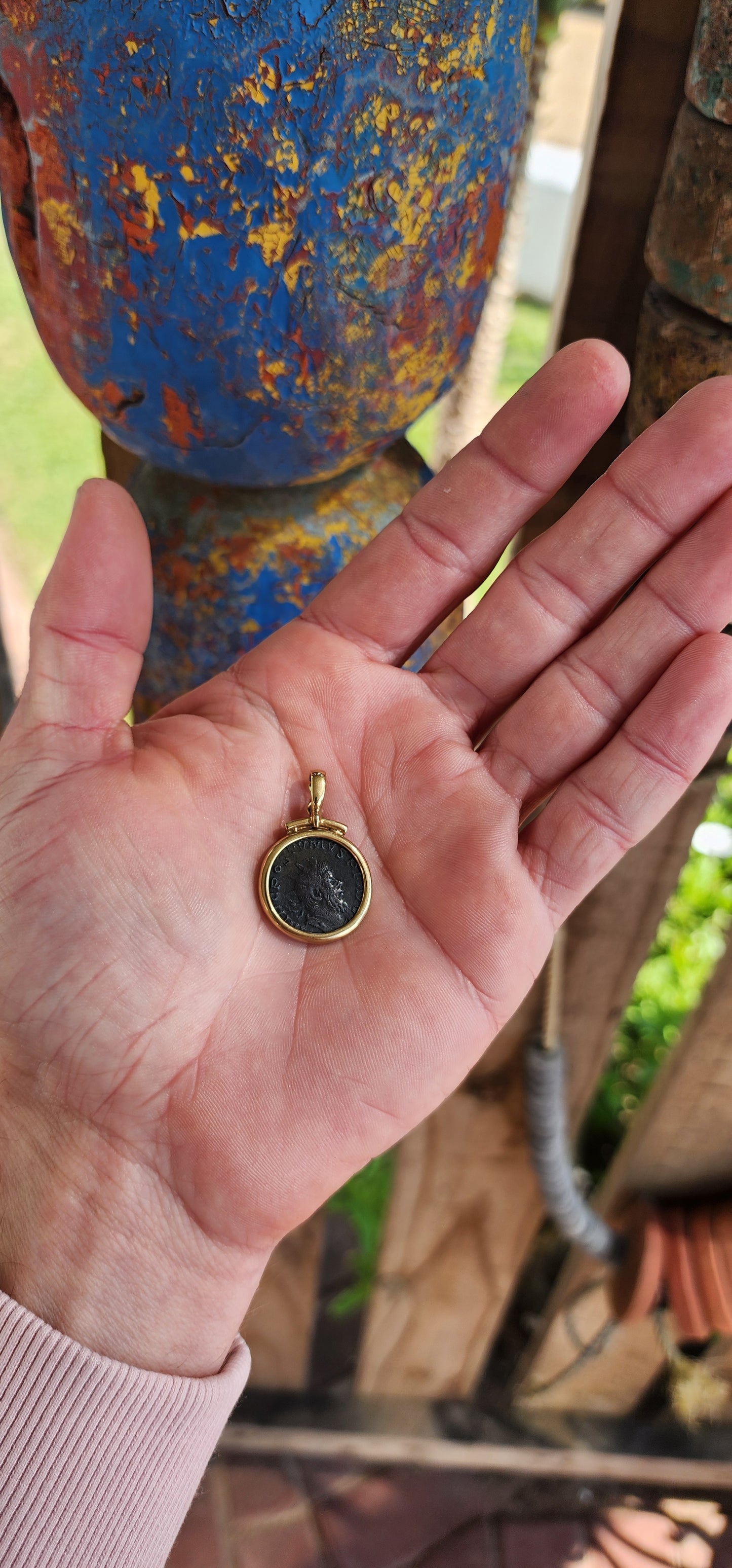 A fabulous Ancient Roman Bronze coin pendant featuring Postumus Antoninianus in a 8ct Yellow Gold bezel with open/close bail.
This pendant features a true Ancient Roman Bronze coin that was lightly circulated and depicts Postumus Antoninianus 260-269 AD.