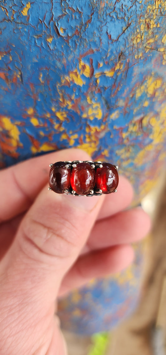 JELLY BABY!!Beautiful Sterling Silver and prong set Oval Garnet Cabochons Trilogy ring.
The little pierced Hearts on the sides of this ring add that extra special touch.