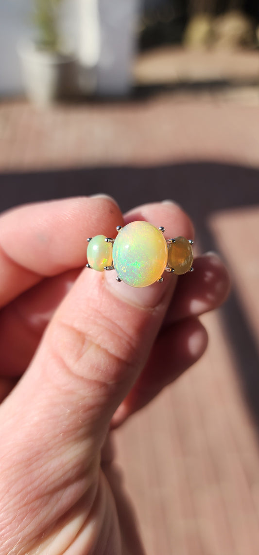 Marvelous Sterling Silver and Orange Ethiopian Welo Opal Cabochons Trilogy ring.This ring forms part of a matching set consisting out of Trilogy ring , earrings and pendant on chain .All Sold separately.