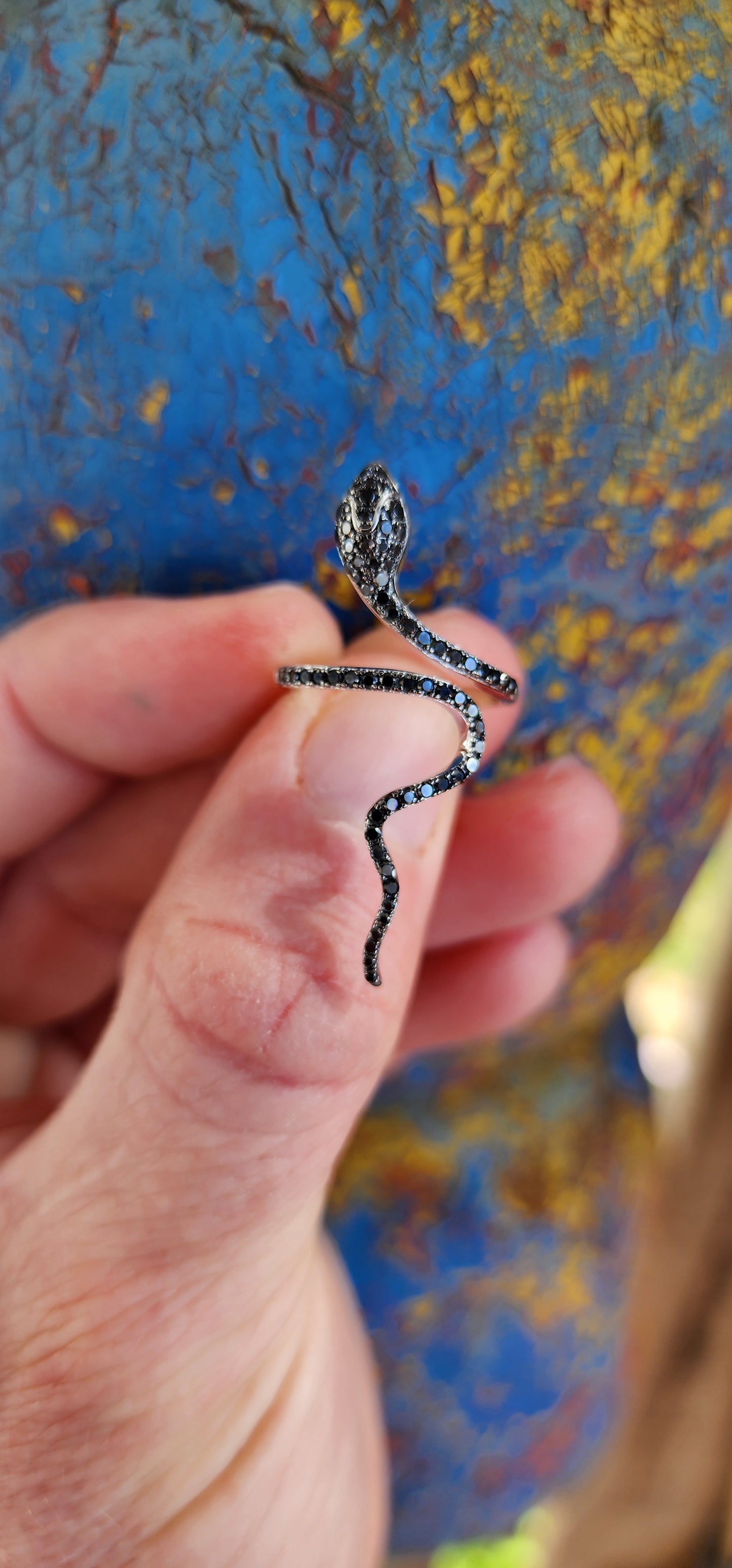 Magical and inimitable Sterling Silver coiling Serpent ring.The Serpent is adorned with pave Black Spinel Gemstones, adding a magical sparkle to its eyes and body.