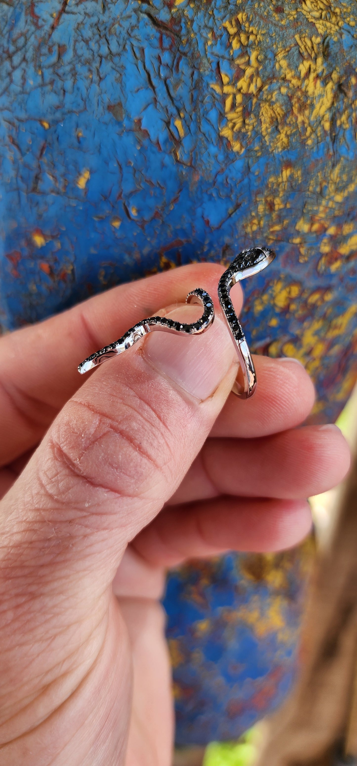 Magical and inimitable Sterling Silver coiling Serpent ring.The Serpent is adorned with pave Black Spinel Gemstones, adding a magical sparkle to its eyes and body.