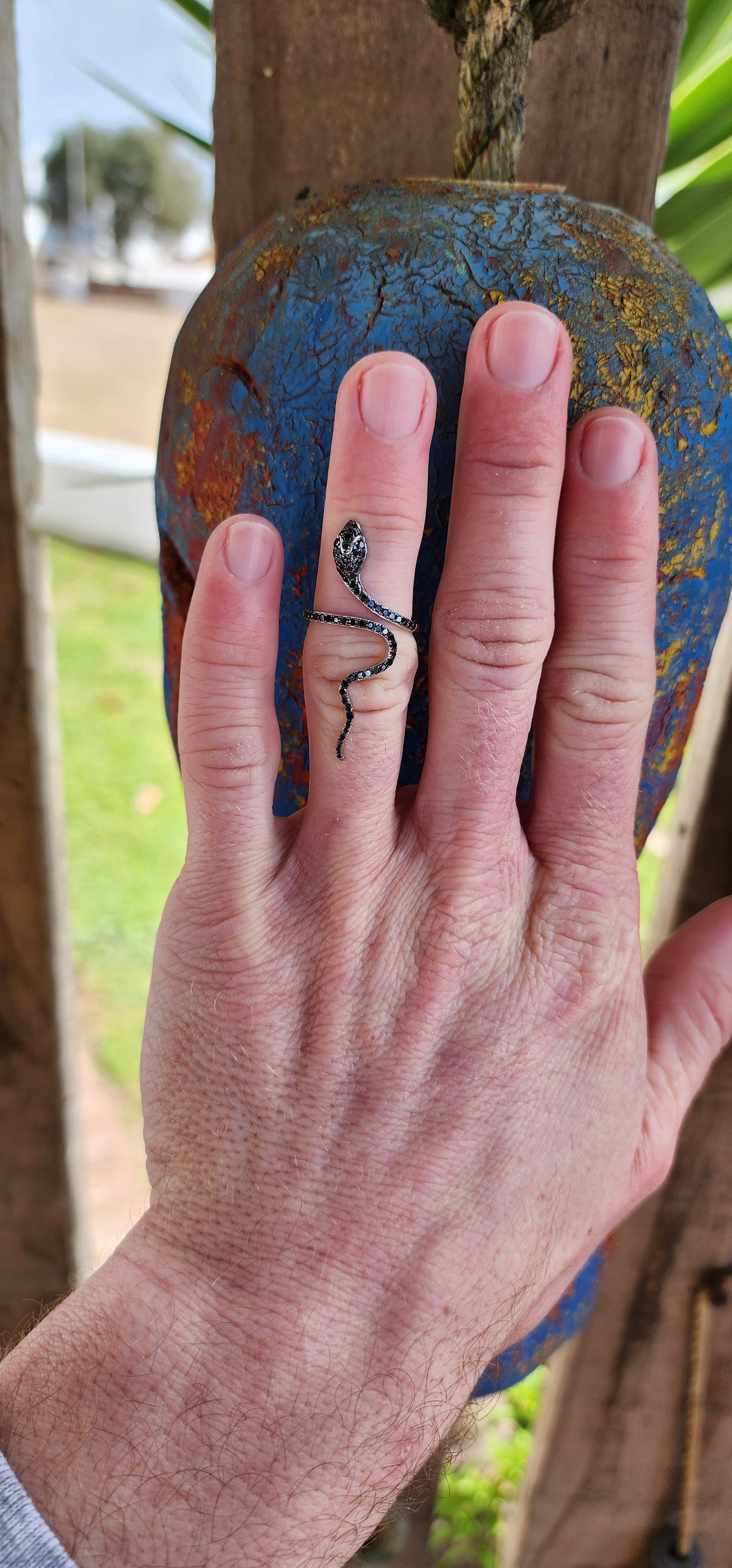 Magical and inimitable Sterling Silver coiling Serpent ring.The Serpent is adorned with pave Black Spinel Gemstones, adding a magical sparkle to its eyes and body.