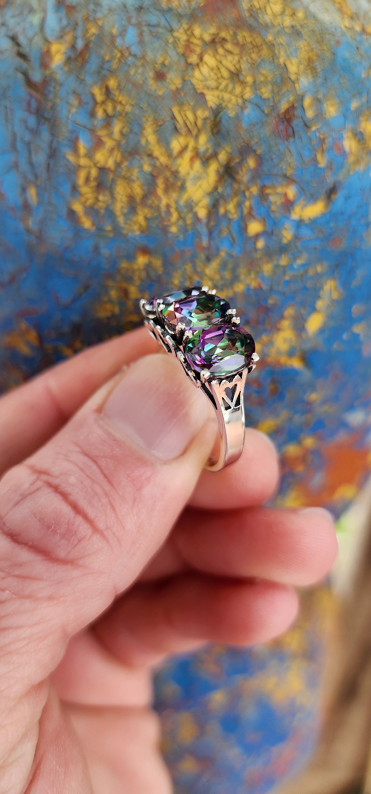 Gorgeous Sterling Silver and Mystic Topaz Gemstones Trilogy ring.This lovely statement ring showcases three enchanting Oval cut Mystic Topaz Gemstones set in prongs.