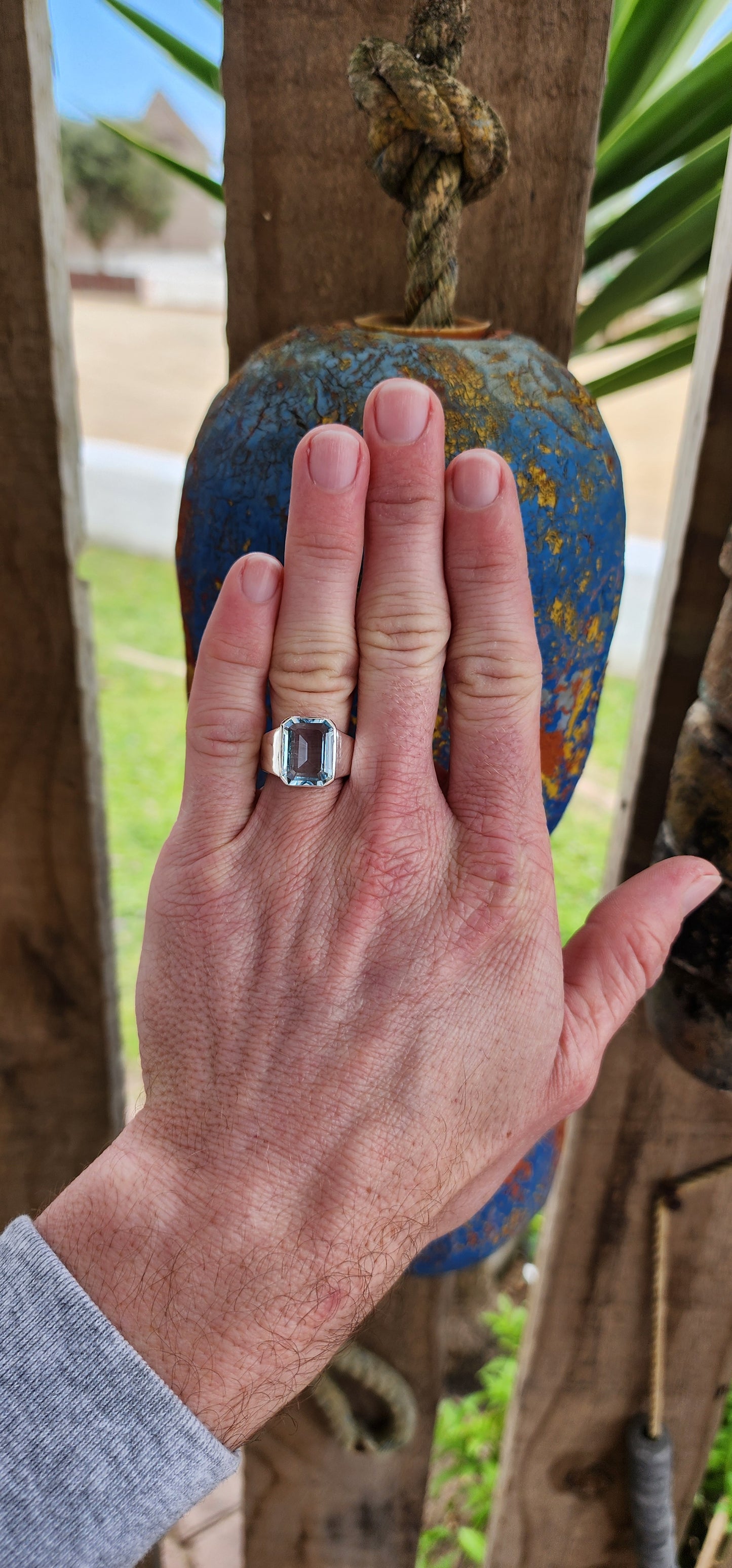 Stunning handcrafted unisex Sterling Silver ring showcases a gorgeous, large Emerald cut Sky Blue Topaz Gemstone set in a bezel/tube setting, with a tapered Silver band.Such an incredibly stunning ring!