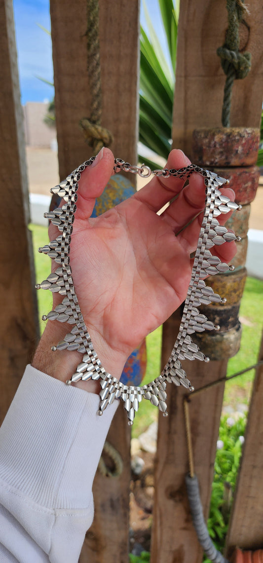 This gorgeous Antique circa 1880's Victorian Hallmarked Silver Etruscan revival articulated book chain collar necklace is made of intricate alternating links with cascading Triangular drops accented with orb edging.