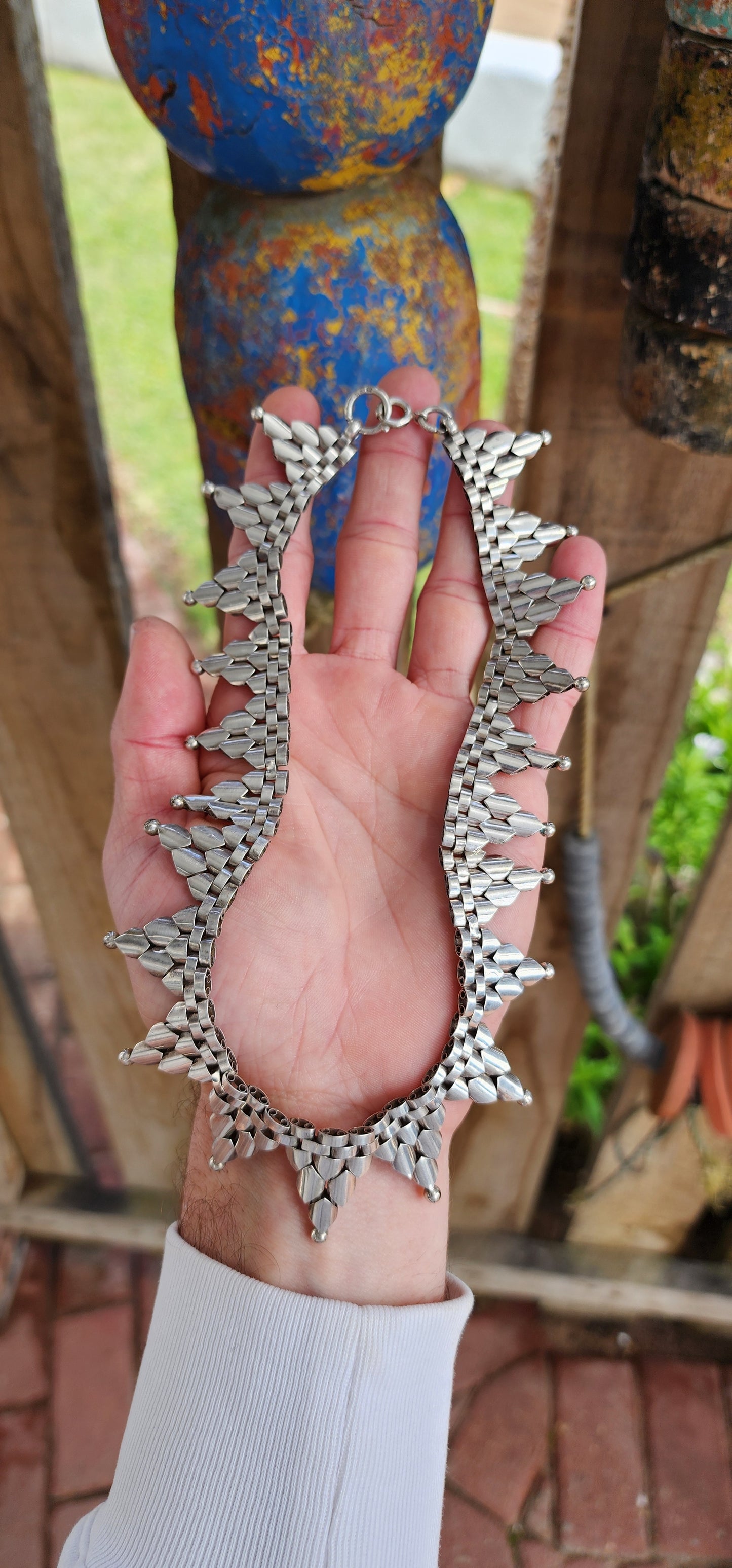 This gorgeous Antique circa 1880's Victorian Hallmarked Silver Etruscan revival articulated book chain collar necklace is made of intricate alternating links with cascading Triangular drops accented with orb edging.