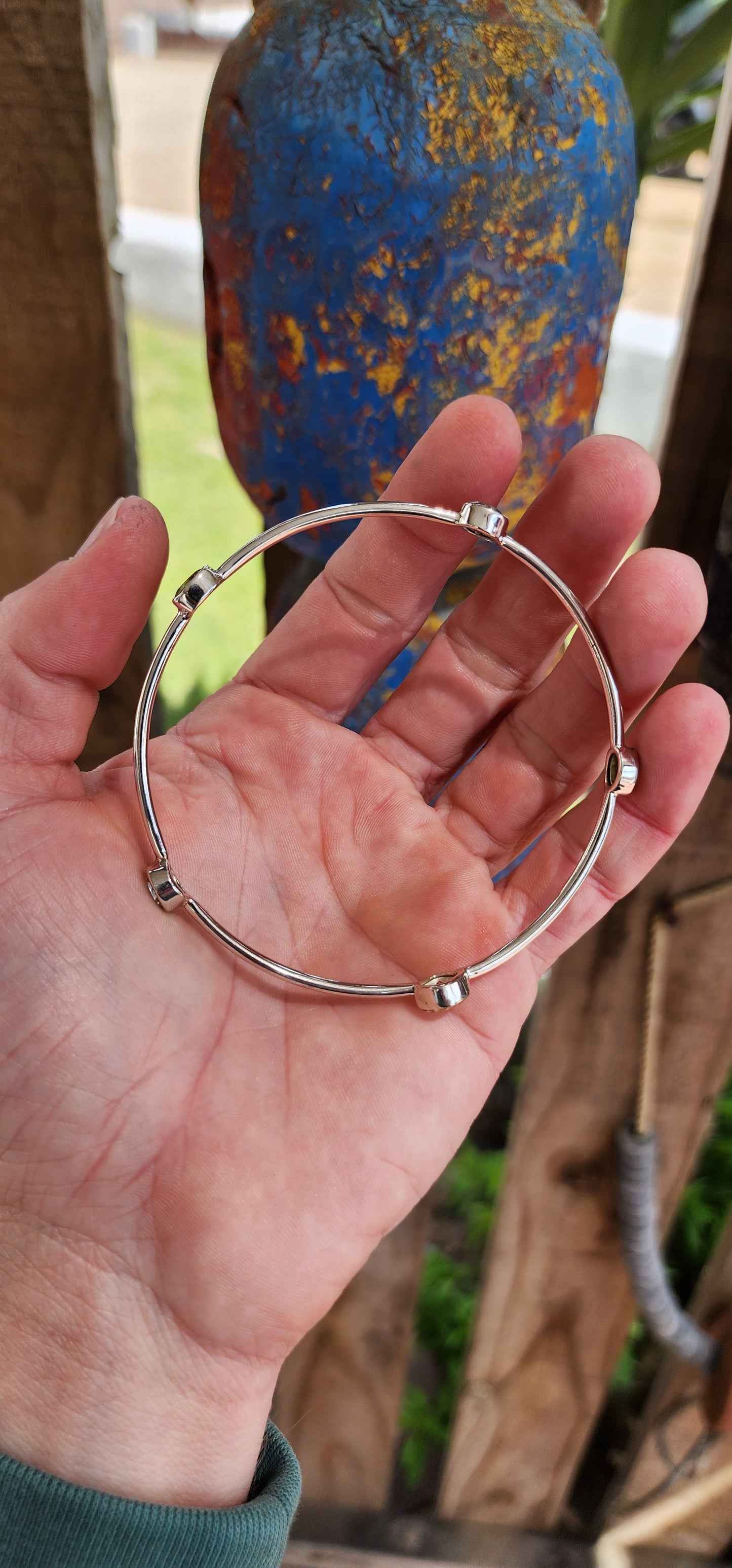 Artsy Sterling Silver ,Citrine, Peridot and Topaz Gemstones bangle.This gorgeous Sterling Silver tube bangle is bezel set with a lovely combinations of Gemstones including 1x Cushion cut Citrine , 2x Oval cut Peridots and 2x Round cut Blue Topaz Gemstones