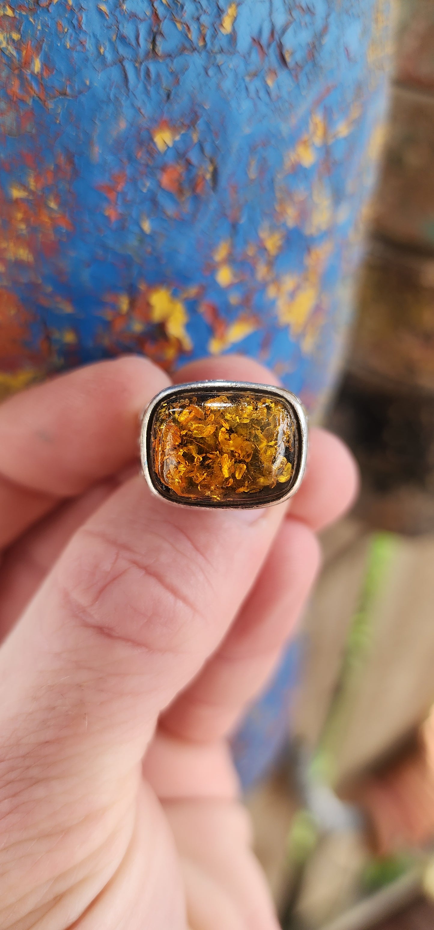 This stunning,vintage and bold ring is a beautiful fusion of timeless elegance and earthy warmth, anchored by the unmistakable charm of a large Baltic amber cabochon.