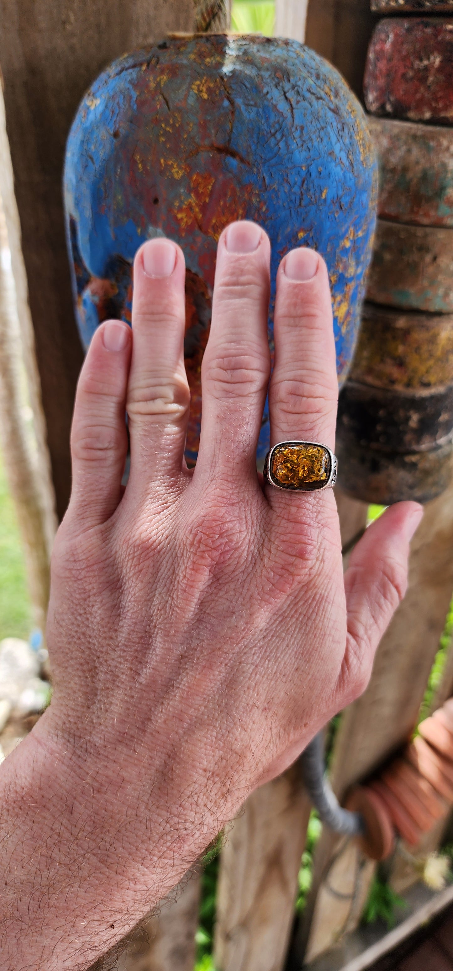 This stunning,vintage and bold ring is a beautiful fusion of timeless elegance and earthy warmth, anchored by the unmistakable charm of a large Baltic amber cabochon.