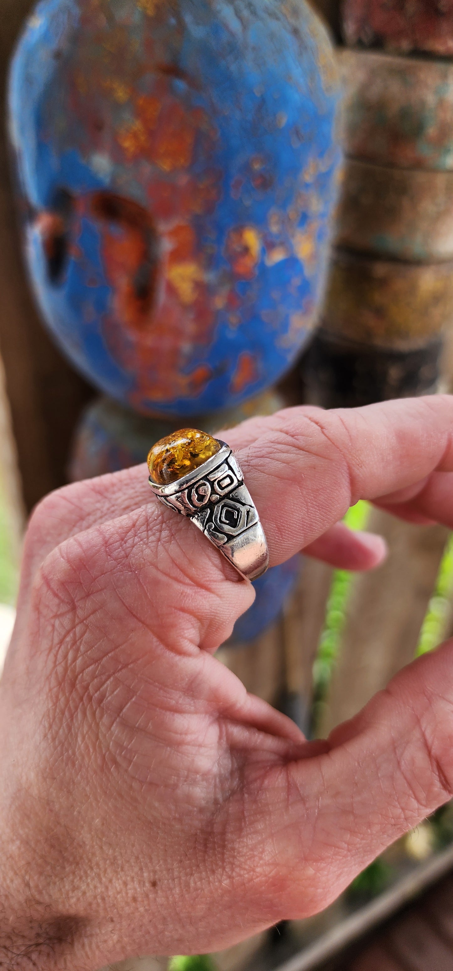 This stunning,vintage and bold ring is a beautiful fusion of timeless elegance and earthy warmth, anchored by the unmistakable charm of a large Baltic amber cabochon.