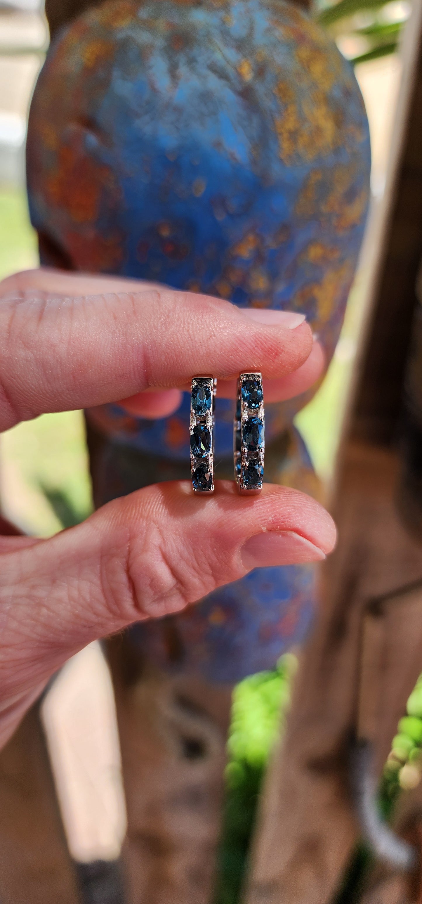 These sterling silver and London blue topaz hoop earrings are a masterclass in refined elegance, designed to make you feel like you're wearing a piece of the evening sky.