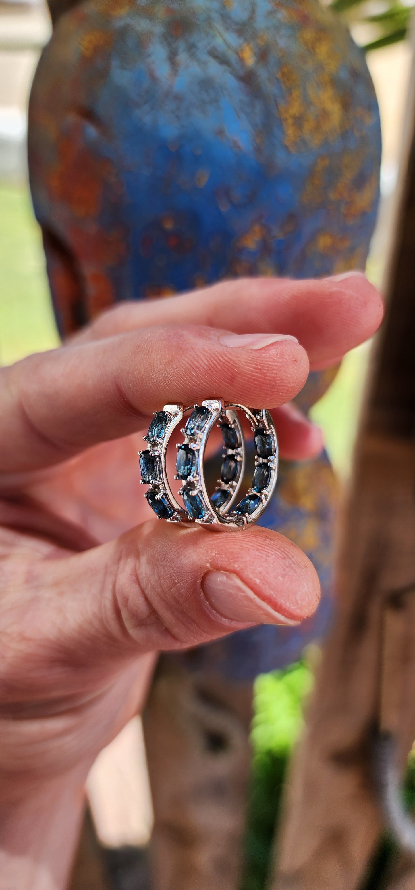 These sterling silver and London blue topaz hoop earrings are a masterclass in refined elegance, designed to make you feel like you're wearing a piece of the evening sky.