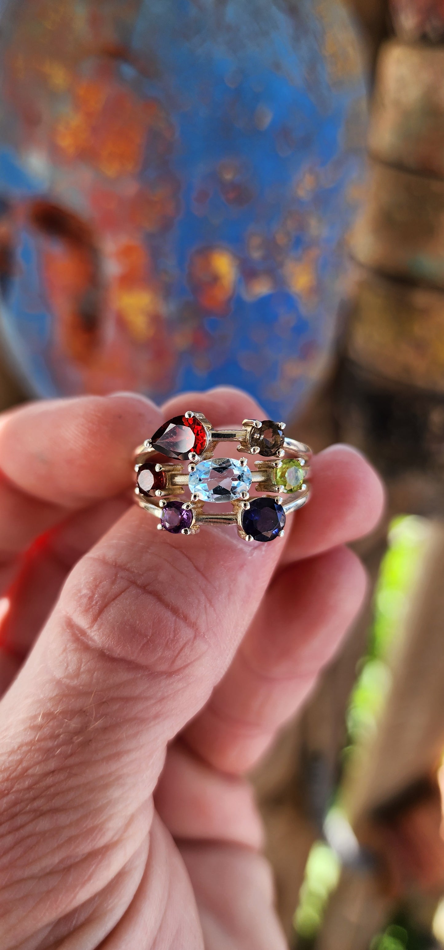 This chunky sterling silver beauty is like a rainbow party for your finger! Sporting a delicious "tutti frutti" lineup of gems, it’s a gemstone extravaganza with prong-set Iolite, Amethyst, Peridot, Topaz, Smoky Quartz, and fiery Garnets.