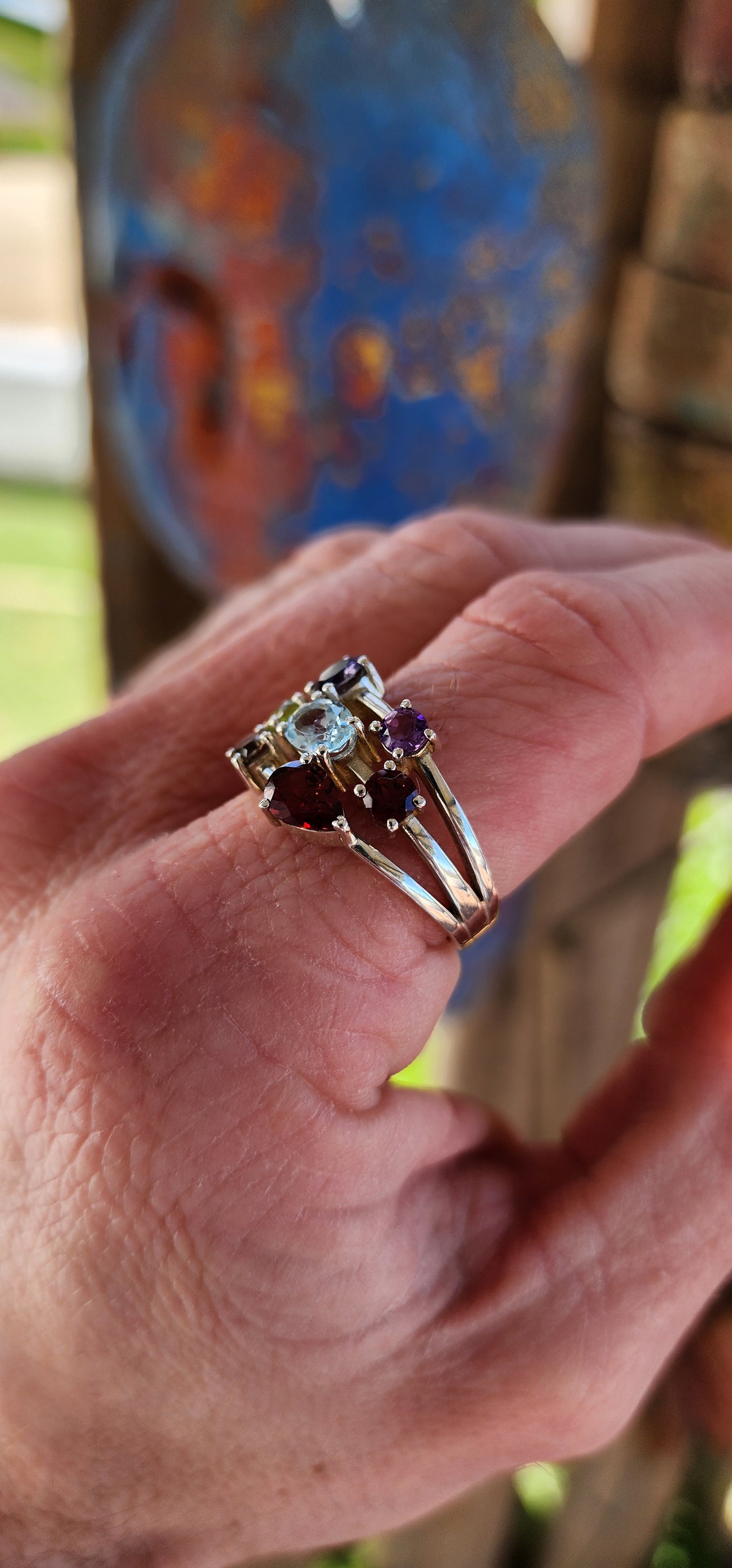 This chunky sterling silver beauty is like a rainbow party for your finger! Sporting a delicious "tutti frutti" lineup of gems, it’s a gemstone extravaganza with prong-set Iolite, Amethyst, Peridot, Topaz, Smoky Quartz, and fiery Garnets.