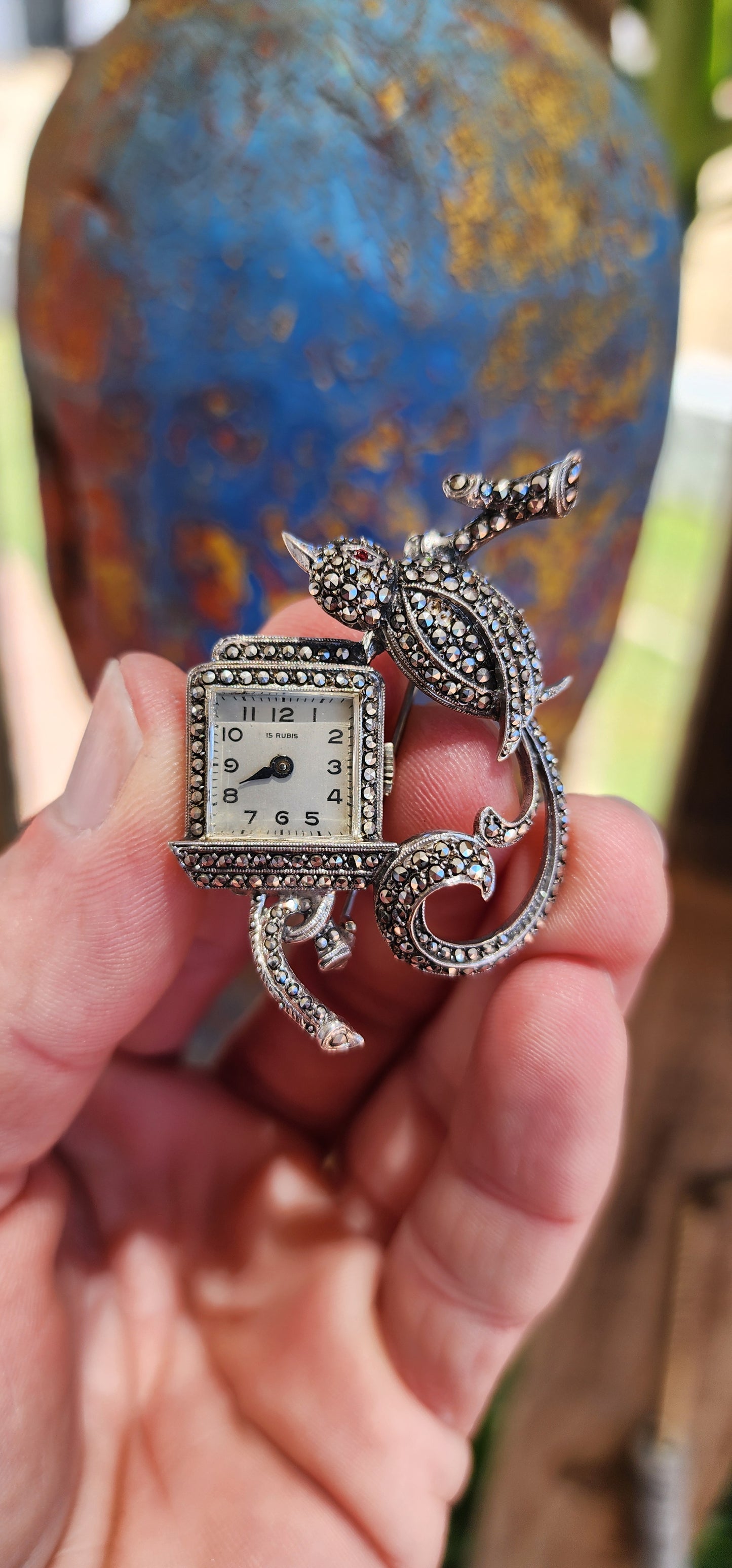 This exquisite piece is a vintage sterling silver brooch-watch, a true testament to the refined craftsmanship of the Art Deco era.