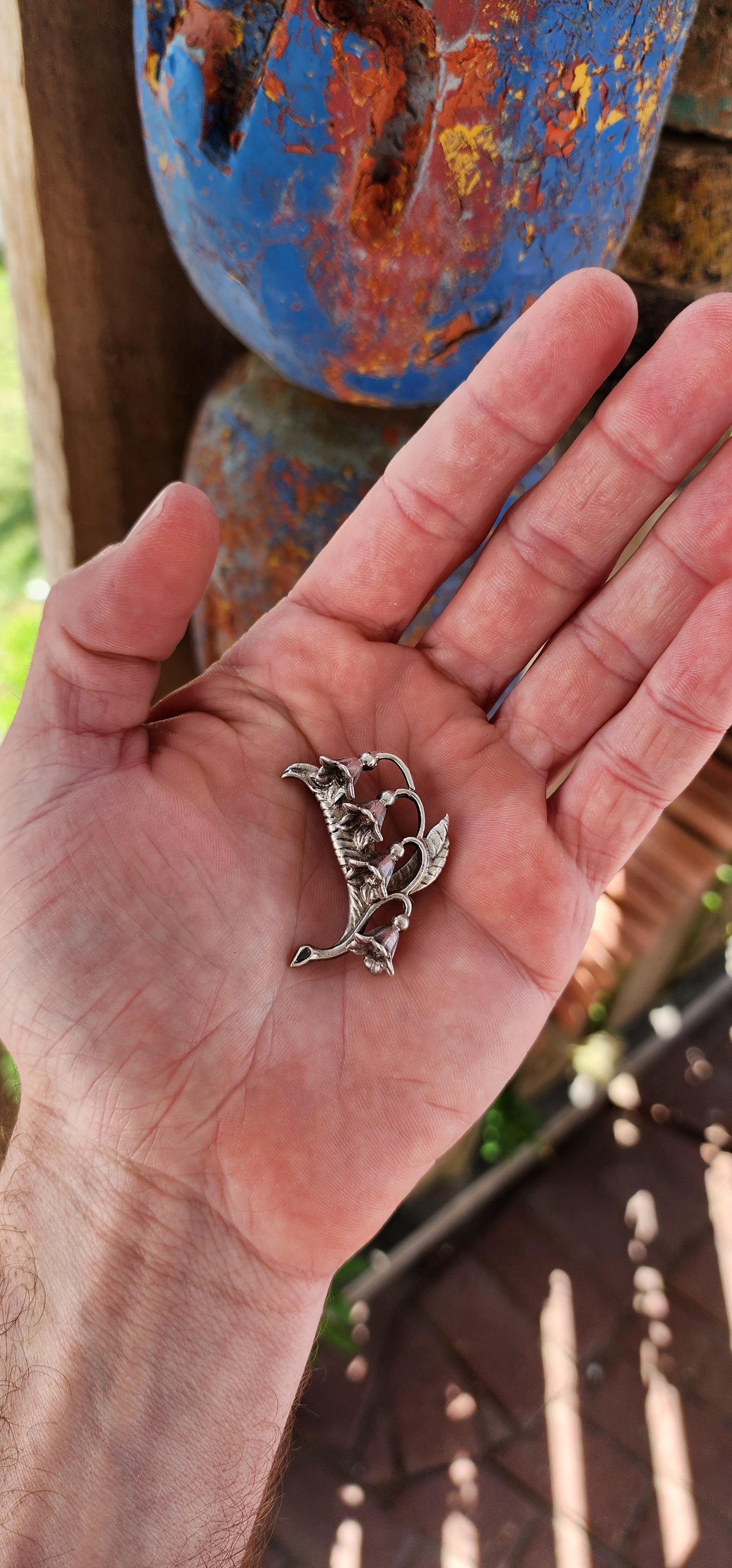 This is a beautifully detailed vintage Art Nouveau era sterling silver brooch in the form of a Lily of the Valley floral design.