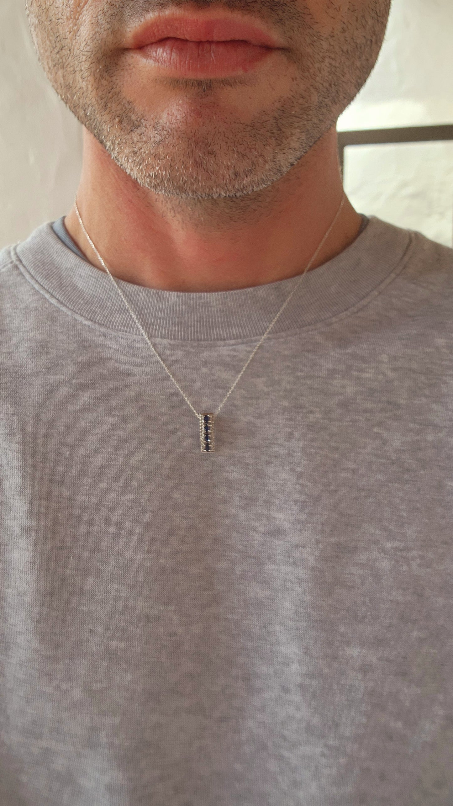 What a striking piece! This sterling silver rectangular pendant radiates an air of minimalist sophistication while packing plenty of sparkle.