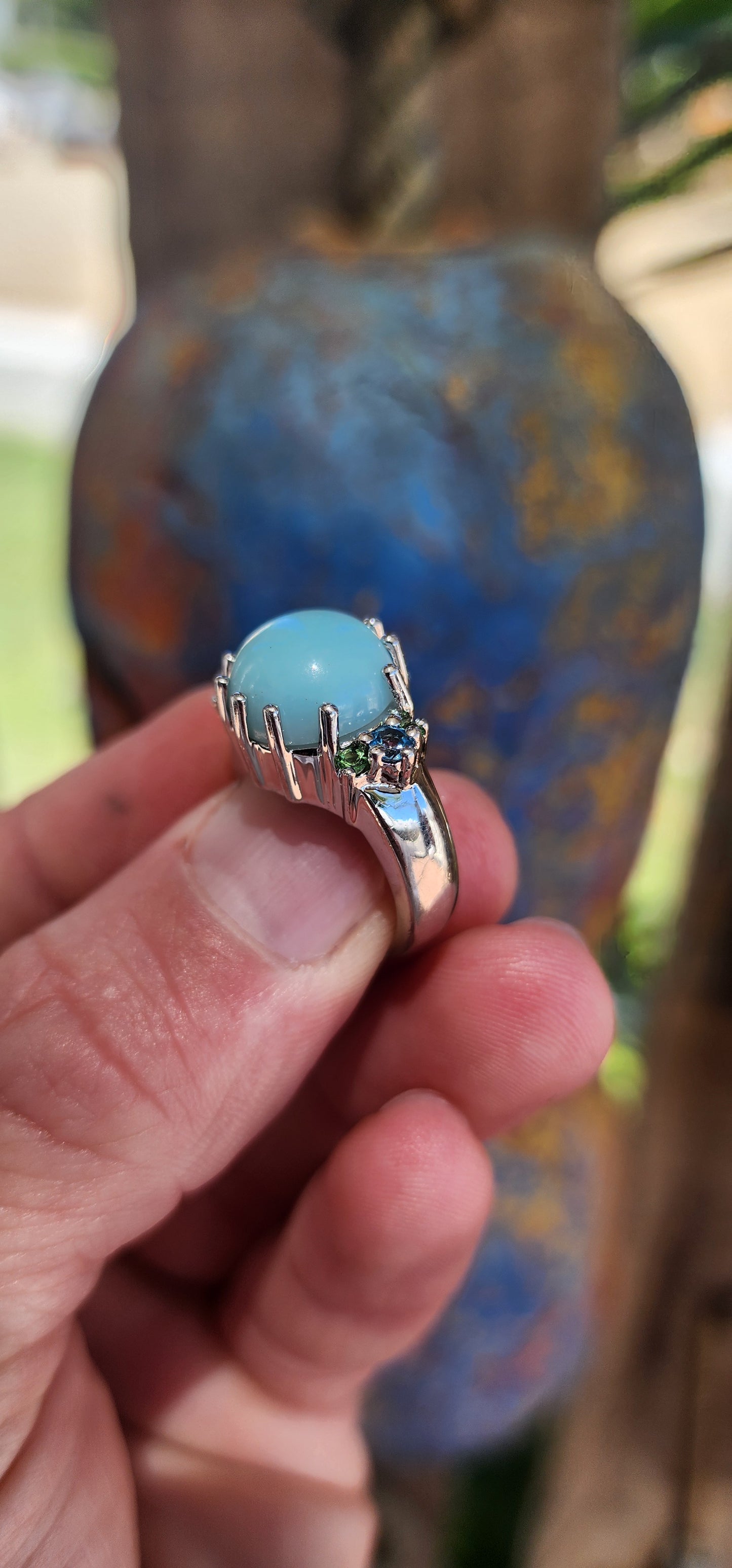 This chunky cocktail ring is like a treasure pulled straight from a mythical ocean's depths. Its sterling silver band gleams like moonlight on water, holding court to a mesmerizing round chalcedony cabochon.