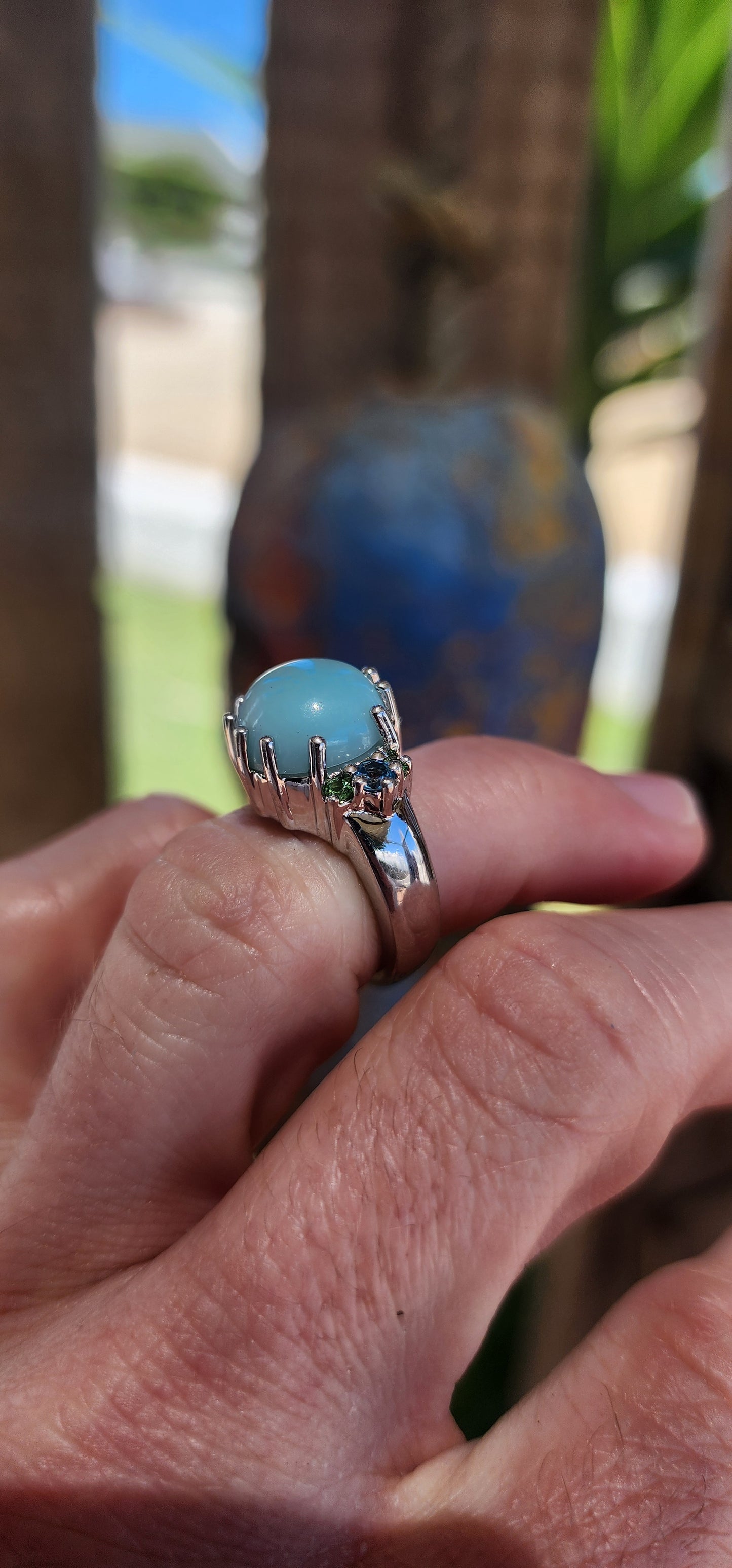 This chunky cocktail ring is like a treasure pulled straight from a mythical ocean's depths. Its sterling silver band gleams like moonlight on water, holding court to a mesmerizing round chalcedony cabochon.