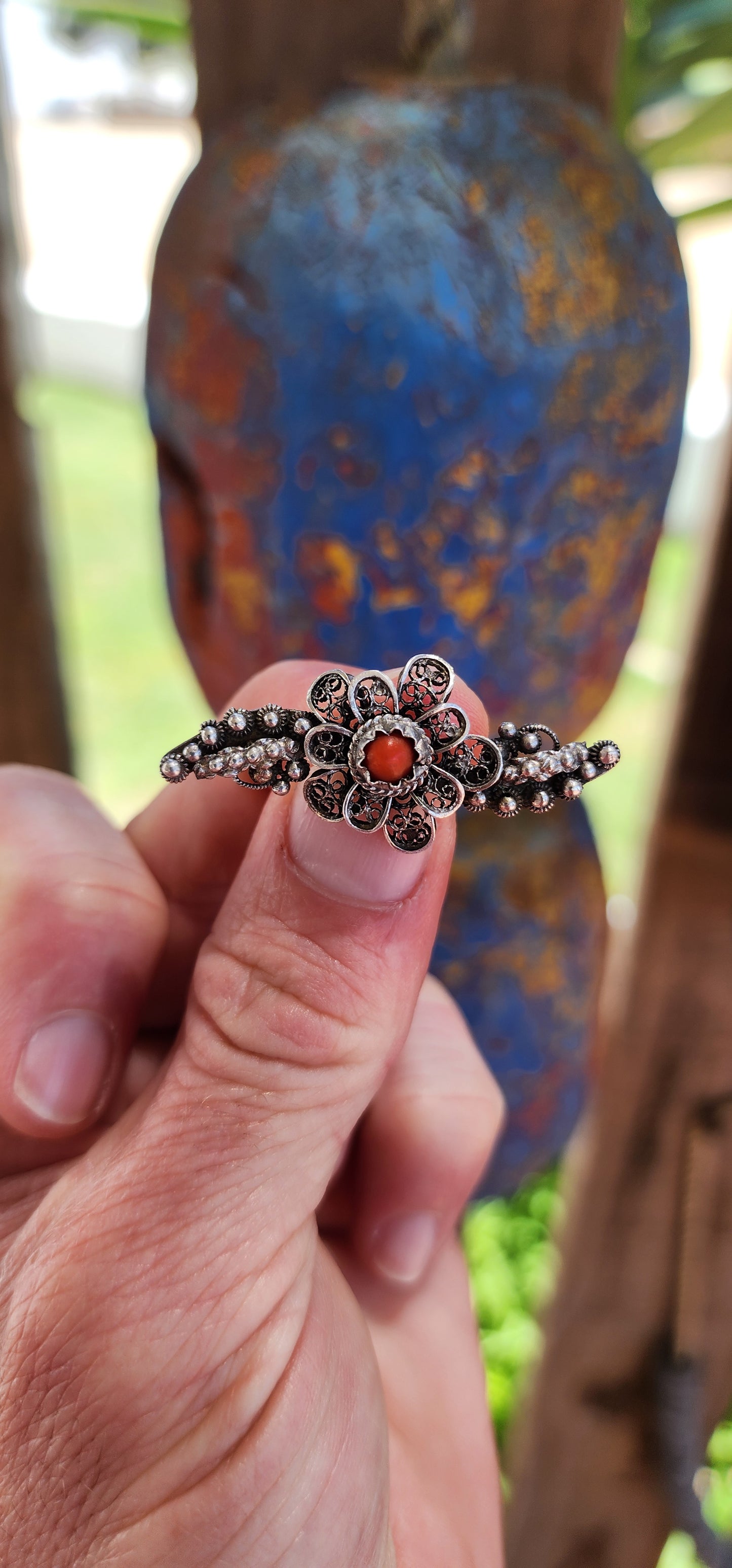 This exquisite brooch is a masterful example of antique Chinese export craftsmanship, showcasing intricate sterling silver filigree work in the form of delicate floral motifs.