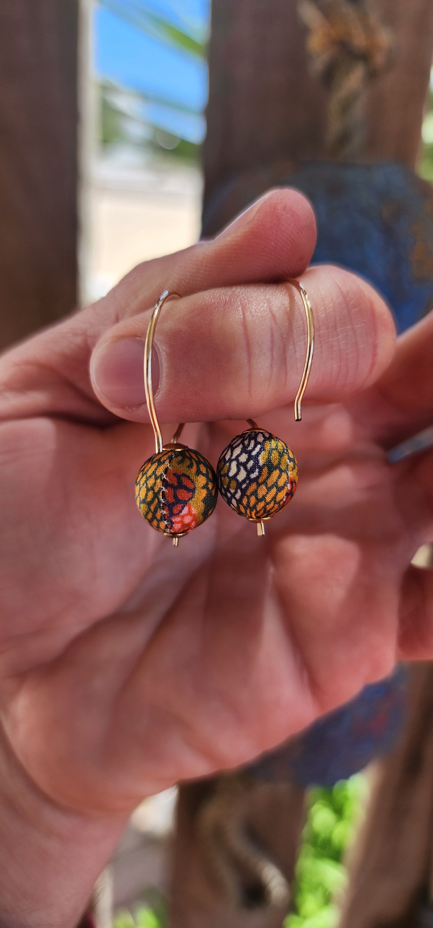 These designer costume earrings are playful and vibrant showstoppers, featuring soft satin fabric spheres in a kaleidoscope of bold colors and patterns.