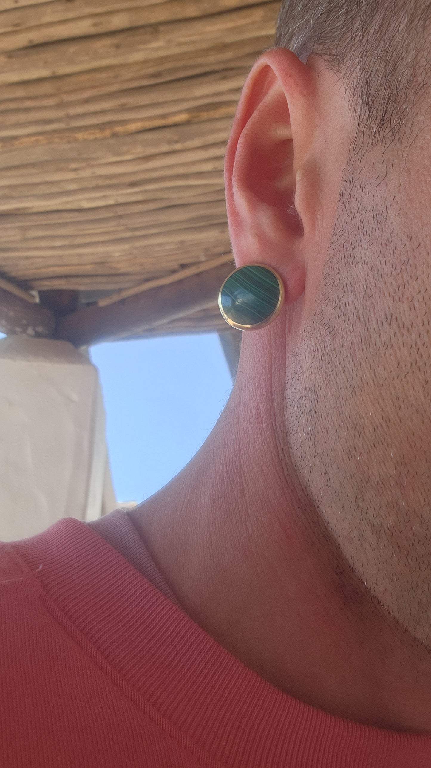 These vintage brass and malachite clip-on earrings exude a bold, modernist flair.