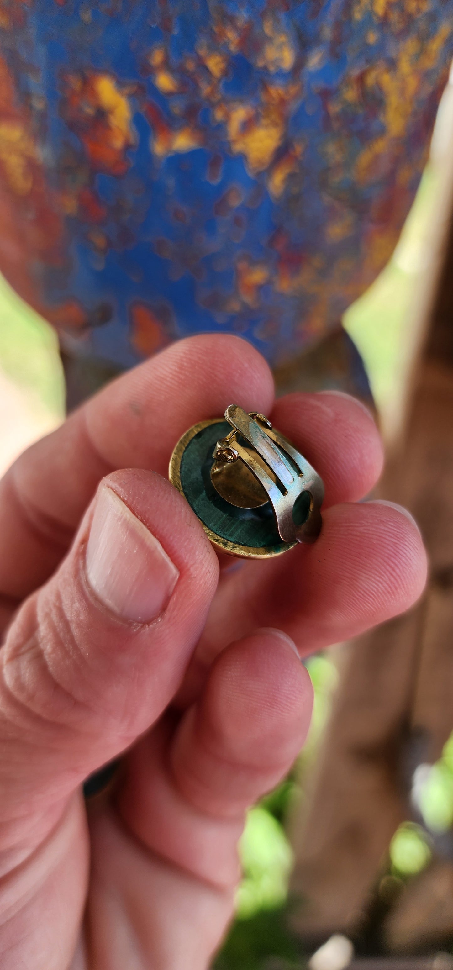 These vintage brass and malachite clip-on earrings exude a bold, modernist flair.