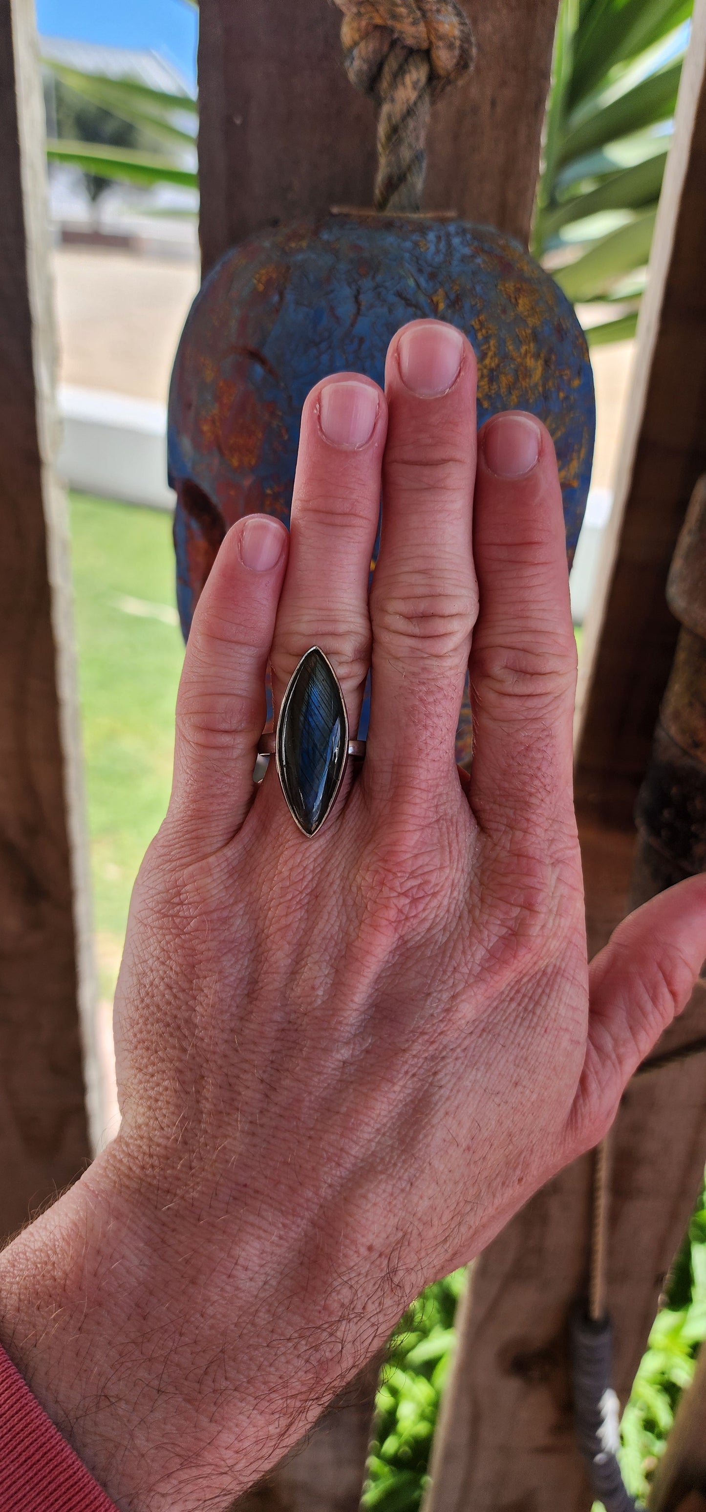 This striking dress ring is the epitome of earthy elegance with a celestial twist. Its sterling silver band features a bold marquise-cut labradorite cabochon, capturing the eye with its signature shimmer.