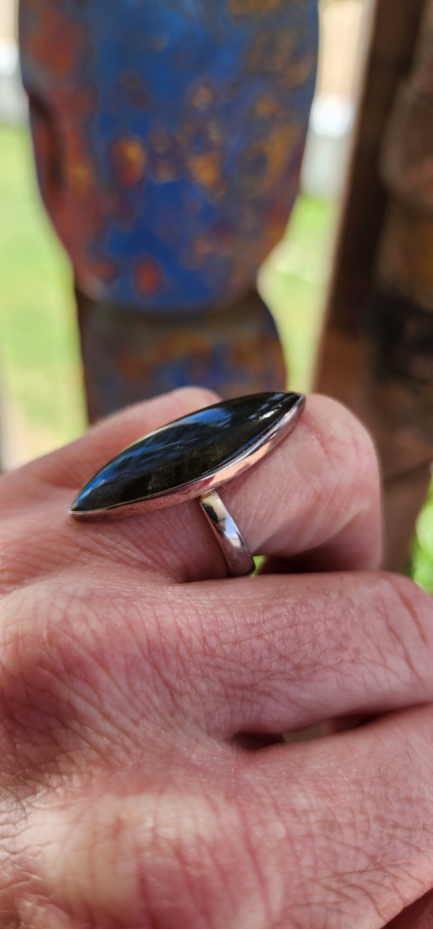 This striking dress ring is the epitome of earthy elegance with a celestial twist. Its sterling silver band features a bold marquise-cut labradorite cabochon, capturing the eye with its signature shimmer.