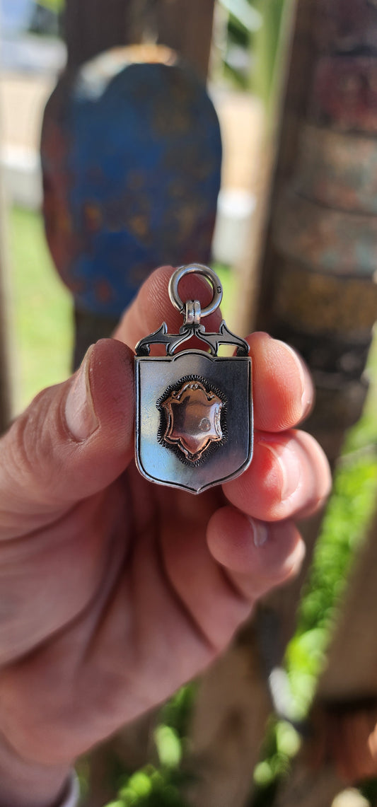 Antique fob shield pendant dating to the early 20th century (1923-24), made from hallmarked sterling silver and 9ct rose gold.