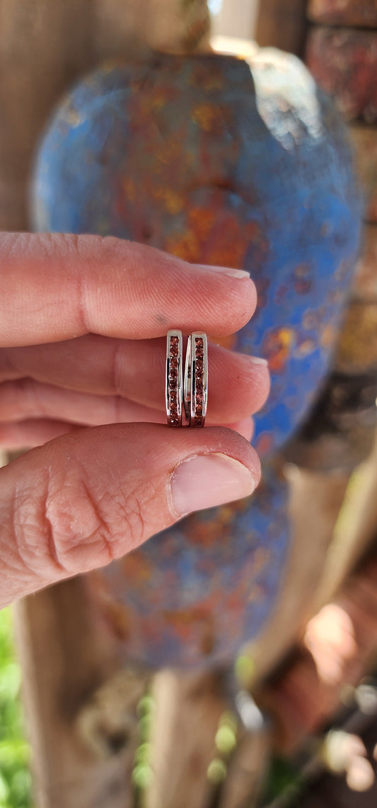 These sterling silver huggie earrings are an exquisite combination of minimalistic and classical design. Each earring is carefully crafted into a sleek, polished oval shape, designed to closely embrace the earlobe for a snug and elegant fit.