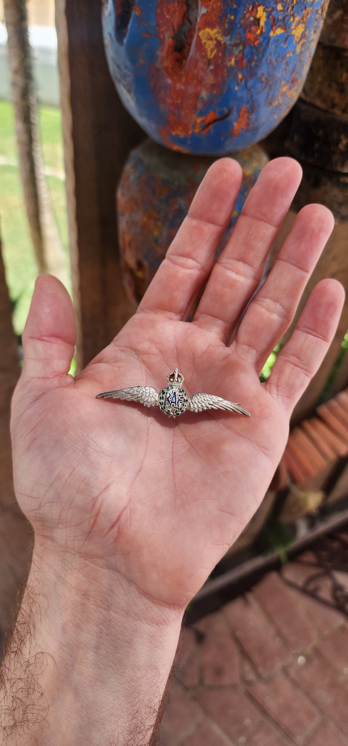 This brooch is a classic example of a World War II Royal Air Force (RAF) sweetheart brooch, crafted in sterling silver and adorned with vibrant enamel work.