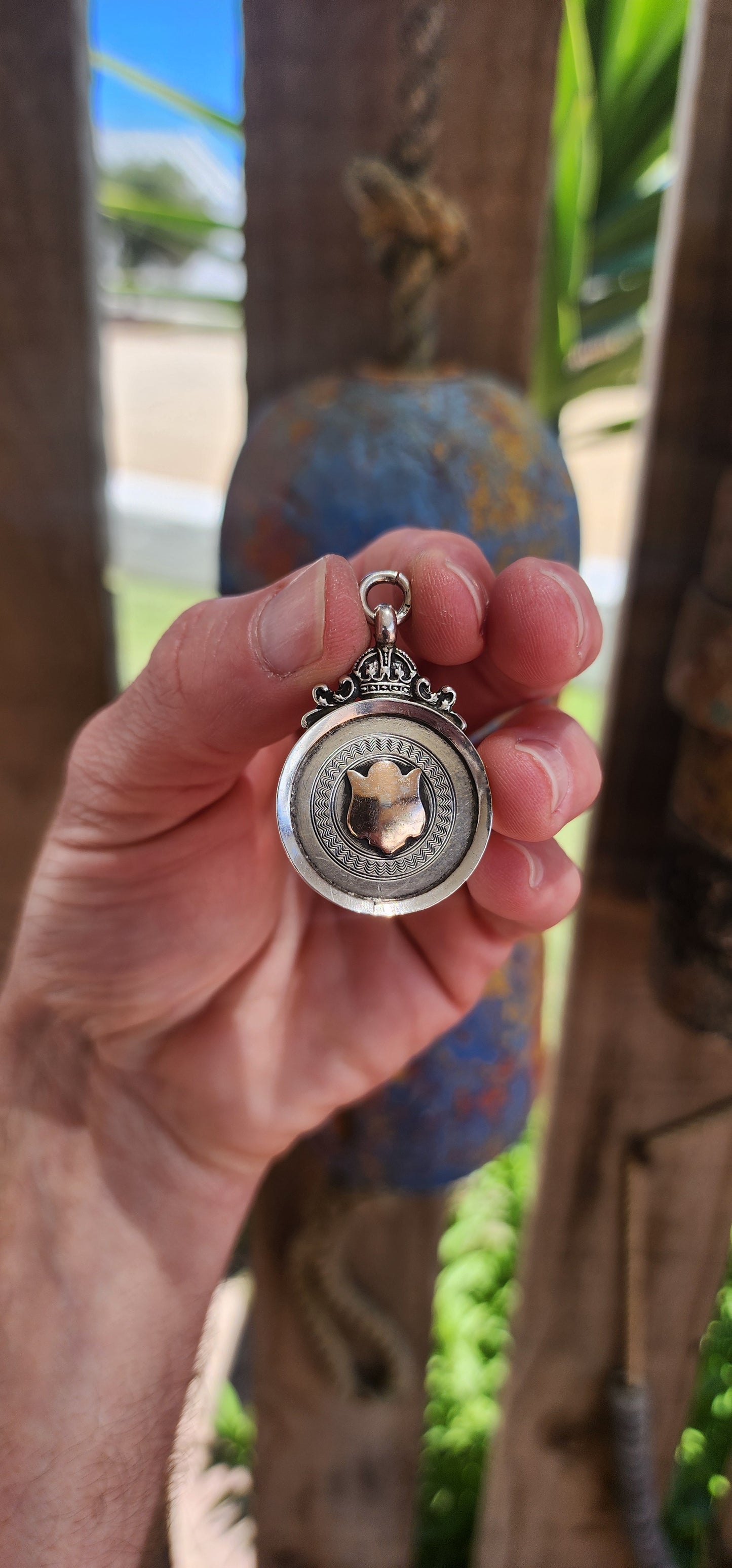 Hallmarked sterling silver and rose gold "crown" fob shield pendant.