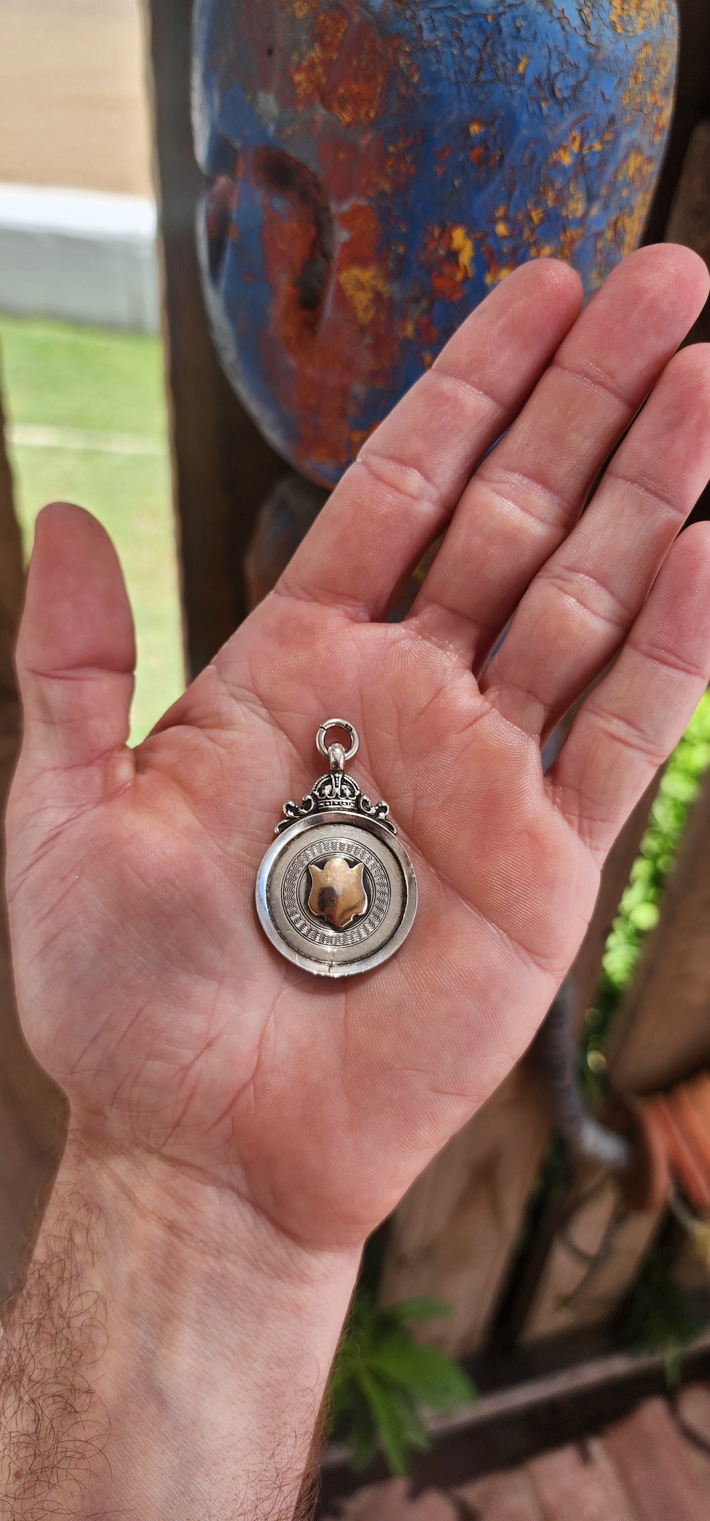 Hallmarked sterling silver and rose gold "crown" fob shield pendant.