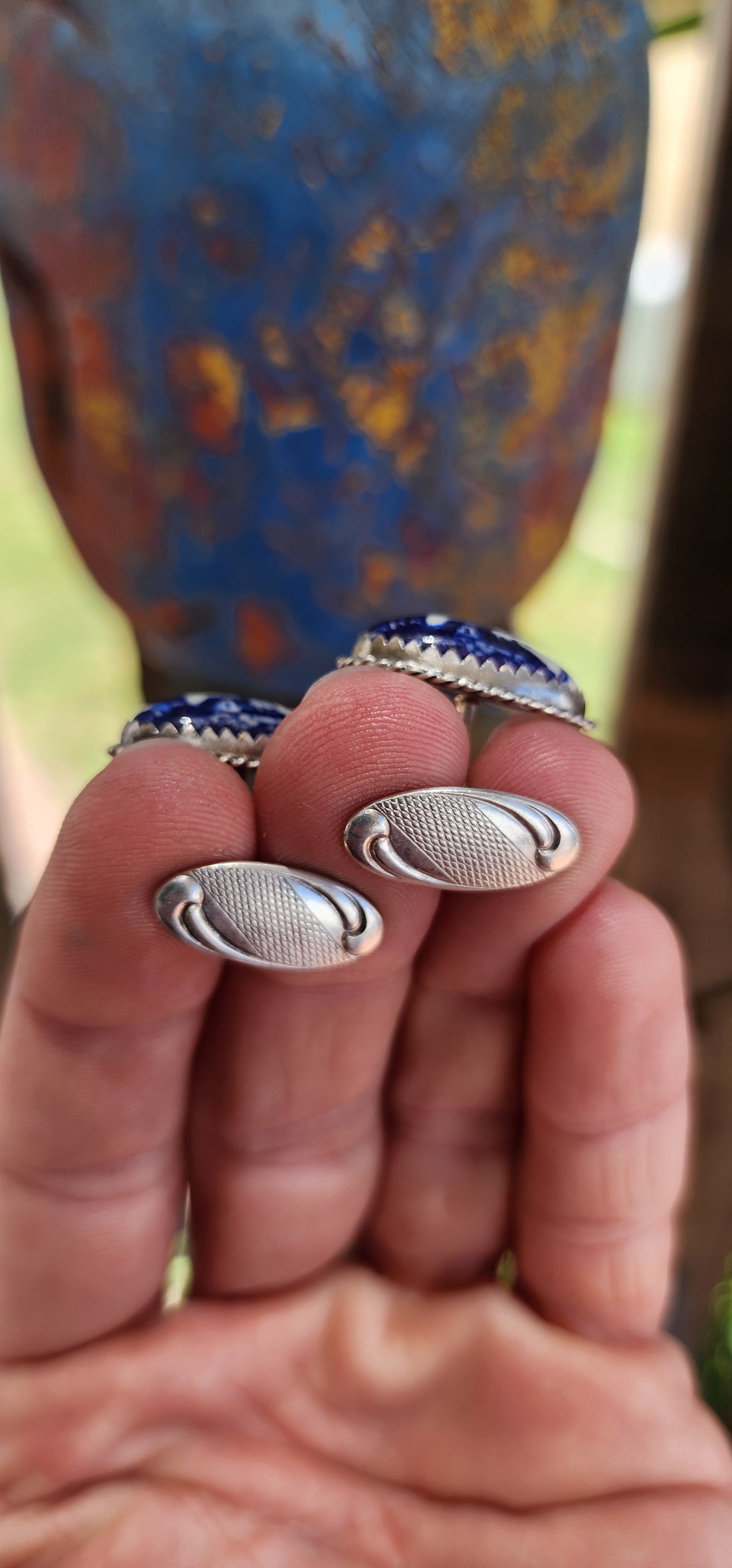 These vintage cufflinks are a remarkable example of mid-20th century craftsmanship, perfectly unisex. They are crafted from 835-grade silver and adorned with Delft porcelain cabochons.