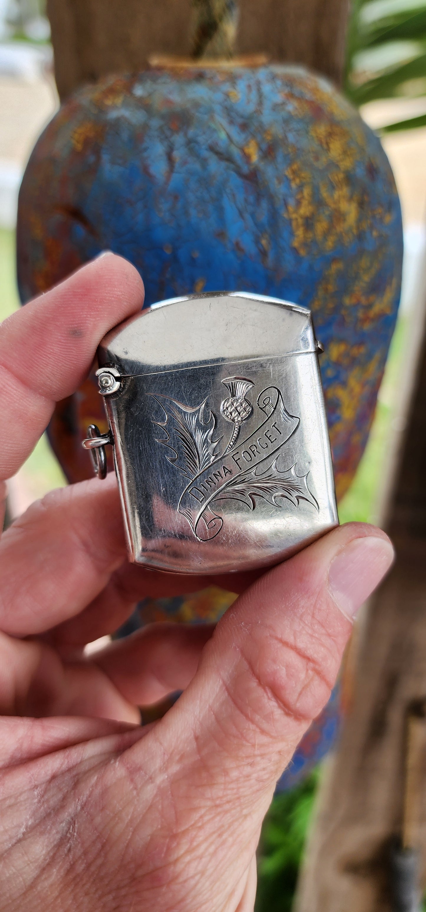 This Edwardian sterling silver vesta case, crafted by William Hair Haseler and hallmarked in Birmingham circa 1908, is a prime example of the intersection between functional design, symbolic artistry, and cultural heritage.