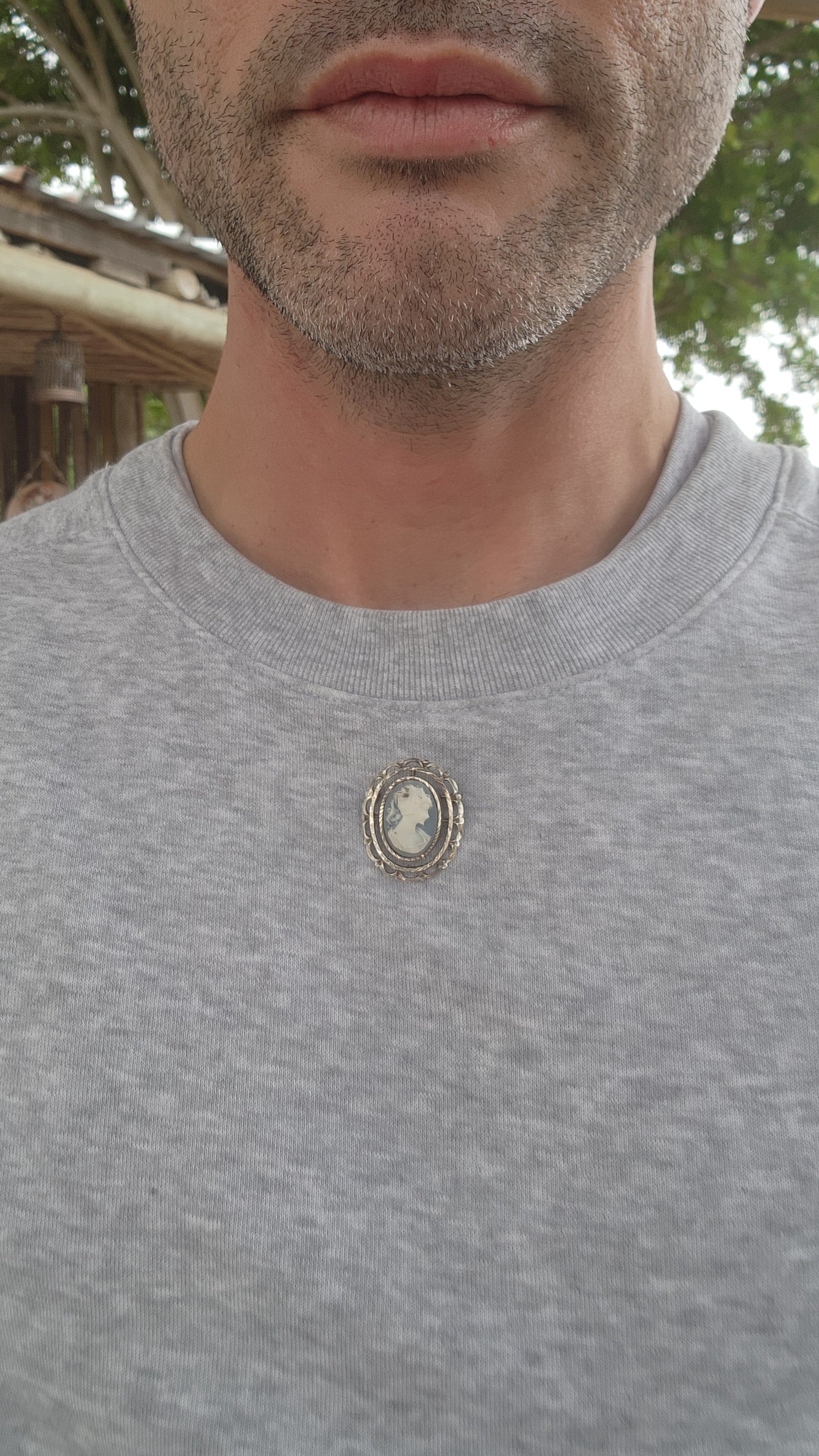 This is a lovely vintage sterling silver brooch featuring a delicate blue cameo crafted from resin.
The centerpiece is an oval blue cameo depicting a classic profile of a lady, likely inspired by Victorian-era motifs.