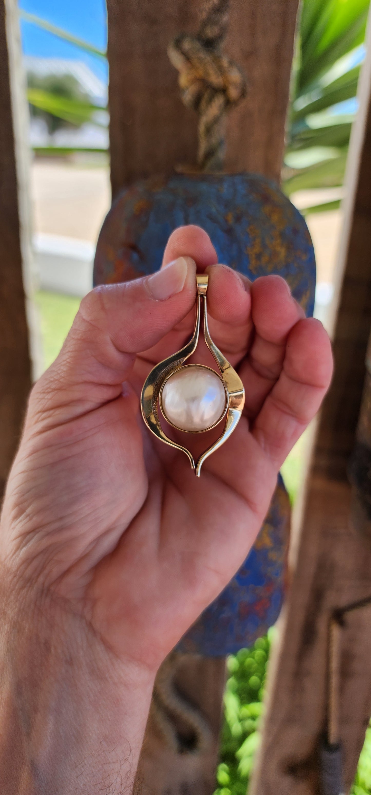 This large vintage pendant is a remarkable blend of modernist design principles and timeless craftsmanship. Made of 9-carat yellowish-rose gold, the pendant carries a warm, subtle blush that enhances its organic aesthetic.