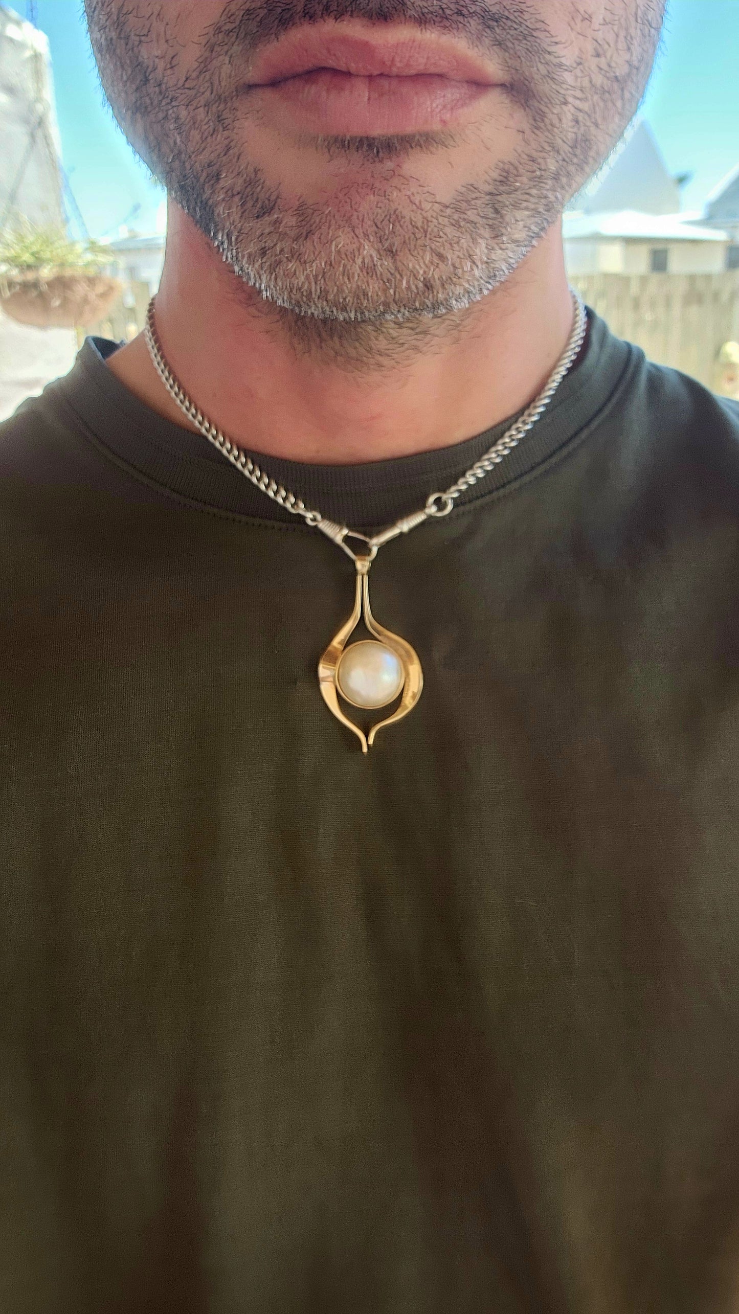 This large vintage pendant is a remarkable blend of modernist design principles and timeless craftsmanship. Made of 9-carat yellowish-rose gold, the pendant carries a warm, subtle blush that enhances its organic aesthetic.