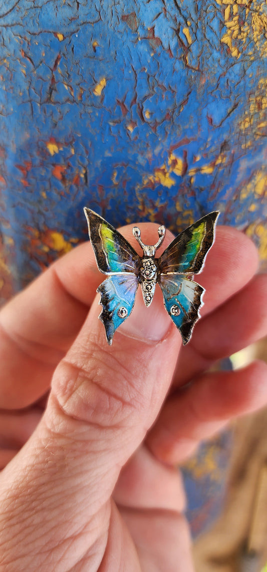 This vintage sterling silver butterfly brooch is a breathtaking work of art, brimming with character and charm. Made in Germany, it showcases the fine craftsmanship and attention to detail characteristic of classic European jewelry.