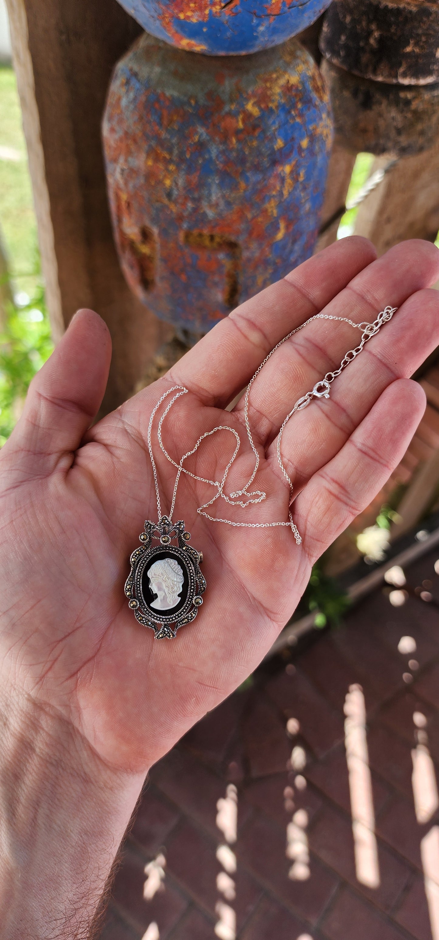 This sterling silver cameo pendant/brooch is a dazzling creation that perfectly captures the opulence of Victorian Revival jewelry.