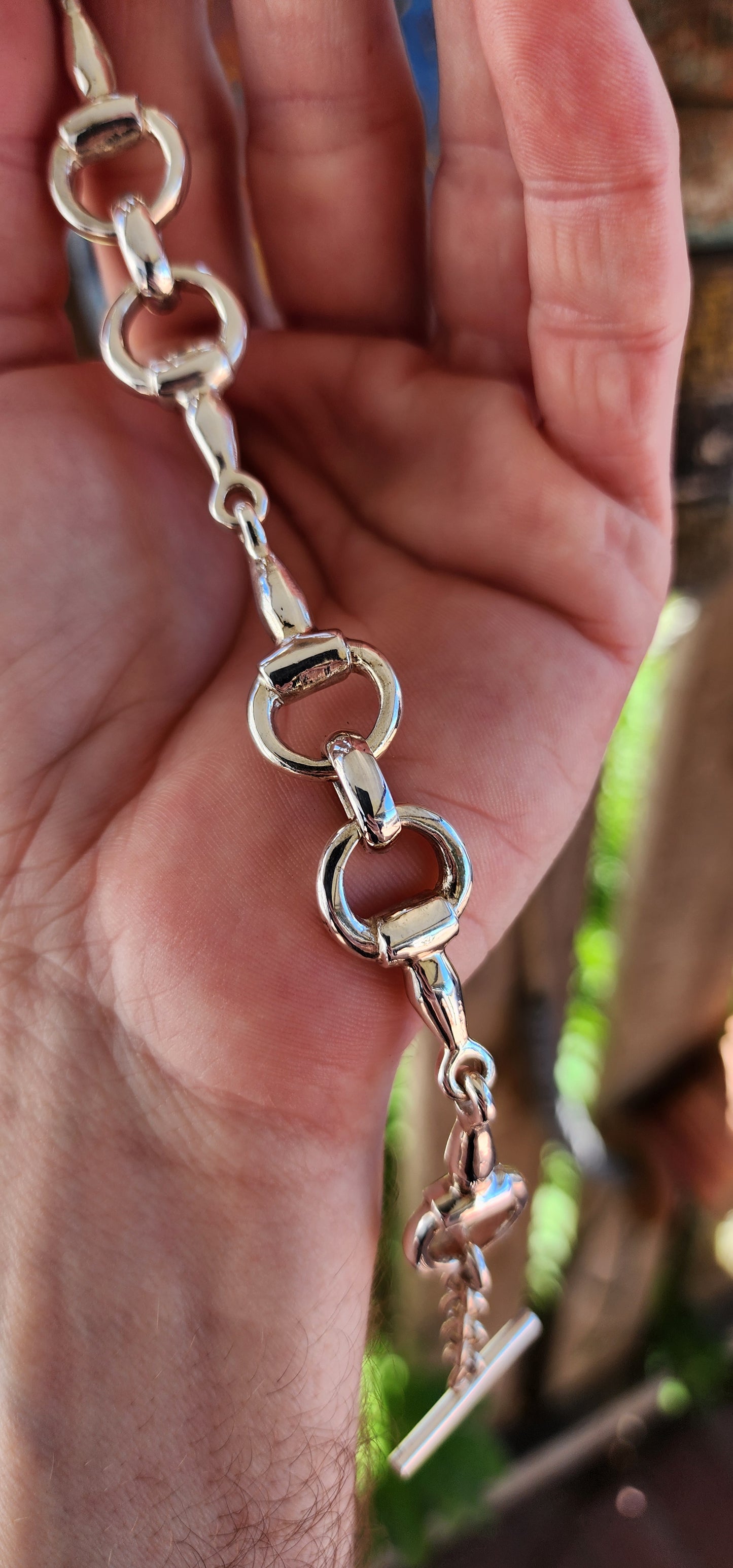 This bracelet is the ultimate showstopper for equestrian enthusiasts and lovers of bold, timeless jewelry. Crafted from chunky, weighty solid sterling silver, it features an intricate design inspired by horse snaffle bits.