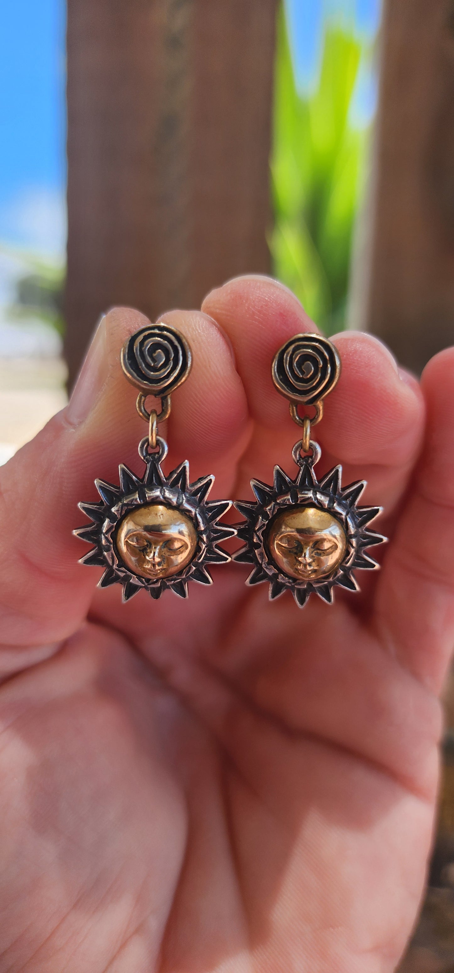 These artisan-crafted vintage push-in earrings are a mesmerizing celebration of celestial beauty. They are composed of two primary elements: sterling silver and brass, working in harmony to create a design rich in texture, symbolism, and contrast.