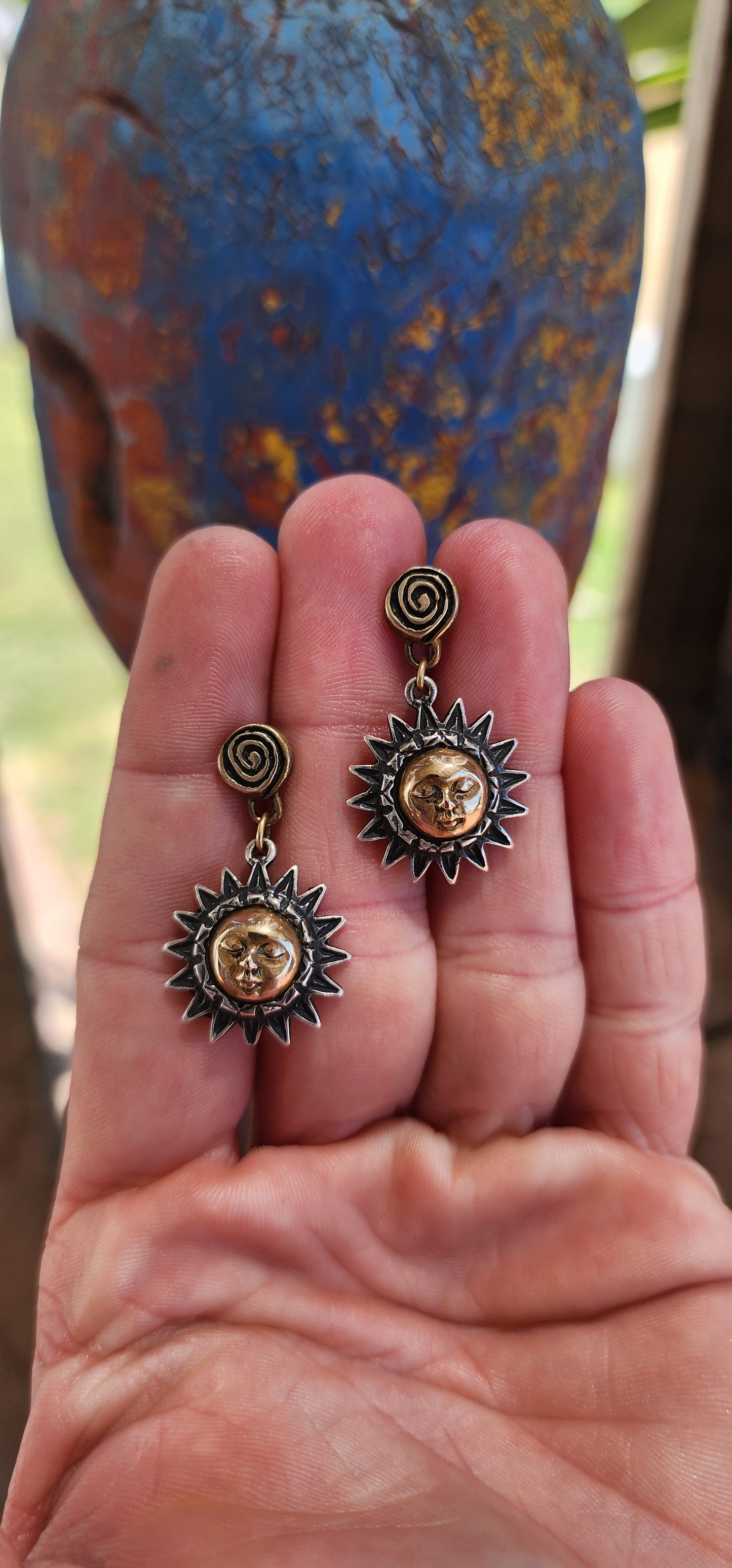 These artisan-crafted vintage push-in earrings are a mesmerizing celebration of celestial beauty. They are composed of two primary elements: sterling silver and brass, working in harmony to create a design rich in texture, symbolism, and contrast.